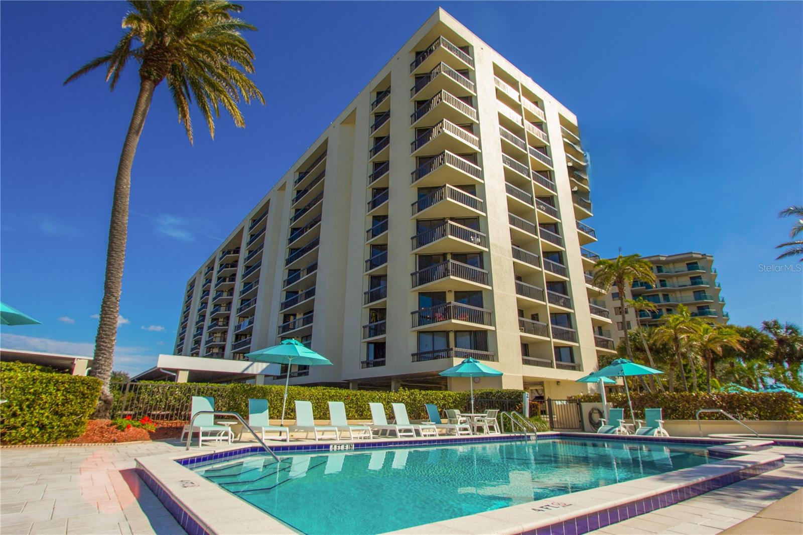 PANORAMIC VIEWS greet you as you enter this beach retreat! This rare updated one bedroom / 1.5 bath with 950 sq. ft. is open, remodeled, and beautifully appointed with coastal touches. As gorgeous as the interior is, you will be pulled out to the expansive balcony to watch the sparkling water and ever-changing scenery of soaring sunsets, boats going by, and dolphin shows in their natural habitat. The balcony spans the length of the condo and has sliders to access in the living room and master ensuite.  Hurricane shutters add to peace of mind.  The updated kitchen features gorgeous countertops, cabinetry with tons of storage, newer appliances and has been opened up with breakfast bar. The master ensuite is large enough for a king size bed, has remodeled sink vanity and large walk-in closet. Added features of this condo is the washer and dryer in the unit, covered parking as well as a storage on the same floor. Yes, this building is pet friendly too. Two pets up to 25 lbs.  Enjoy resort like amenities: waterfront heated pool, hot tub, tennis & pickleball courts, shuffleboard, BBQ grills, picnic area, bicycle storage, car wash, and boardwalk for sunset strolls. Owners can purchase or lease boat slips from individual owners. Island Walk is a well-maintained and fully funded building for buyers' peace of mind. Building updates:  Automated lobby door with key fob, hurricane impacts doors, new mailboxes, security cameras, pool heaters and pumps, walkways 2024, painted in 2022. new roof in 2021 along with common area A/C units updated. 2018 Balcony / railing / patio gemstone coating. Island Walk is a true waterfront oasis and a great opportunity for a new home, second home or new investment property.  Island Estates is a self-contained waterfront paradise offering fine dining, Publix Grocery store, Sushi, Market / Deli, Bar & Grill, UPS Store, 2 Nail Salons, Dry Cleaners, Gas Station with auto repair and Clearwater Marine Aquarium! Just a short walk, bike ride or Jolley Trolley ride over to the consistently #1 ranked Clearwater Beach. YOU'LL LOVE LIVING THIS WAY!