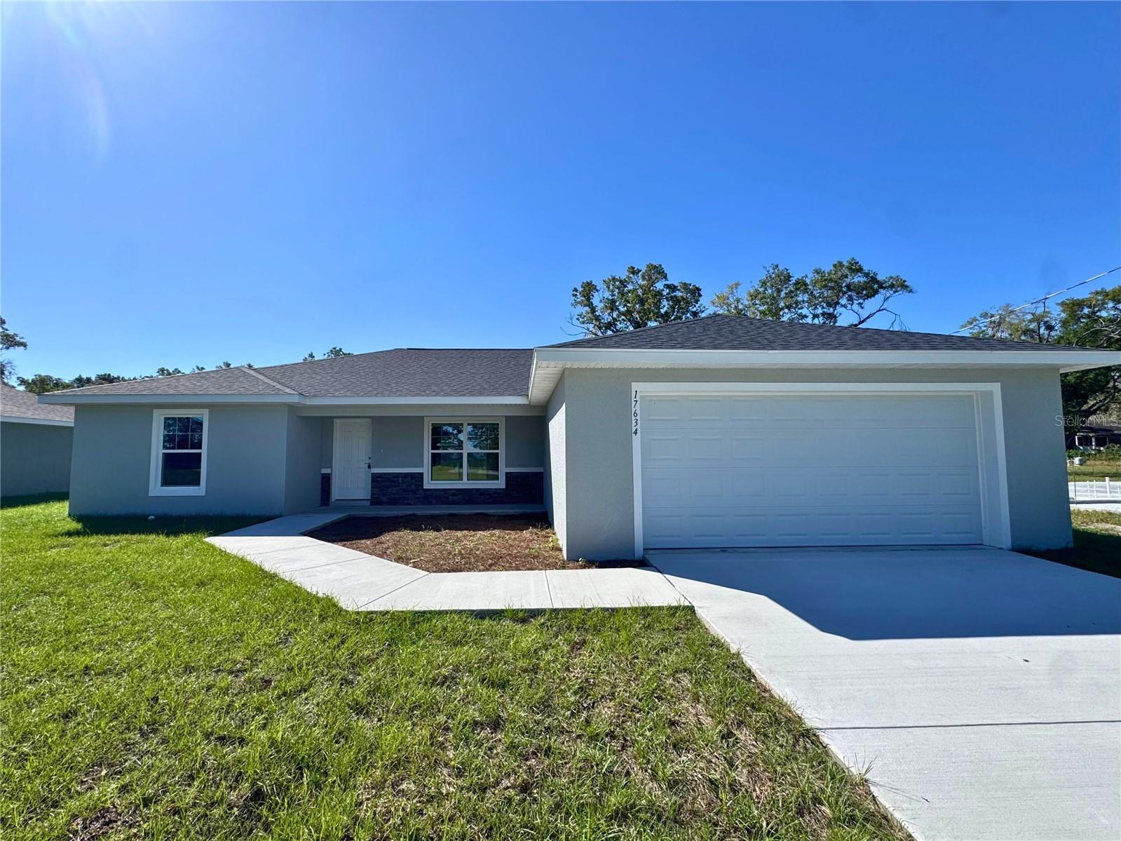 One or more photo(s) has been virtually staged. MOVE IN READY!! Beautiful new construction home in Marion Oaks! Located on a paved street, beautiful mature trees in the back yard, ad no HOAs! Luxury Plank Vinyl flooring throughout all living and common areas, tile in bathrooms, and carpet in the bedrooms. Open floor plan with dedicated dining room and large kitchen island area, all done in neutral, pleasing colors. Inside laundry with W & D hook-ups. Walk-in closet + regular size closet in Master bedroom and a double-vanity in master bath. Stainless steel appliance package in the kitchen. Cabinets are white shaker-style with light luxury granite countertops. Please see attached documents from Builder (Builders Contract Addendum & Warranty) Actual photos are currently unavailable. Any photos depicted are for illustration purposes only and only to show layout. Floor plan displayed is our standard plan and garage orientation may vary on actual home. Interior and exterior colors, finishes, and garage orientation will vary for actual home. Information is deemed correct, but no guarantee made. Any dimensions listed are approximate. ***Inquire about our preferred lender deals! Builder offering to contribute to buyer’s closing costs or help with rate buy downs! We can be flexible to help our buyers get into a beautiful home! ***