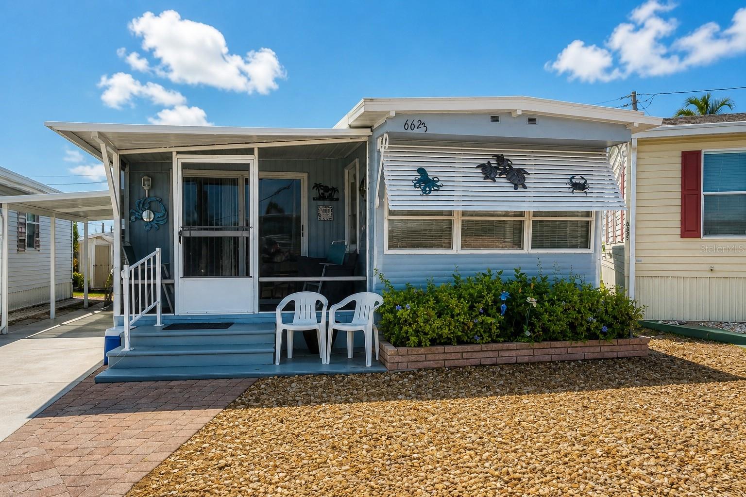Welcome to 6623 Washington St in the sought-after Trailer Estates community. This updated 2-bedroom, 2-bath home features an open floor plan designed for comfortable everyday living and easy entertaining.

The recently upgraded kitchen showcases Corian countertops along with updated finishes that flow seamlessly into the main living space. Improvements throughout the home include updated flooring and renovated bathrooms, giving it a fresh, move-in ready feel.

Enjoy relaxing on the screened front porch—perfect for morning coffee or evening breezes. A covered carport adds convenience and protection, rounding out this well-maintained property.

Located in Trailer Estates, a Special Park and Recreation District governed under Chapter 418, Florida Statutes, residents own their land—no lot rent, CDD, or HOA fees. The annual park tax covers cable, high-speed internet, trash pickup, fire and rescue services, and access to outstanding amenities including a marina with rentable boat slips, private beach, pool, hot tub, fitness center, shuffleboard, bocce ball, pickleball, woodshop, and nearly 60 active clubs and social events. Experience one of Sarasota Bay’s most vibrant and welcoming 55+ communities.