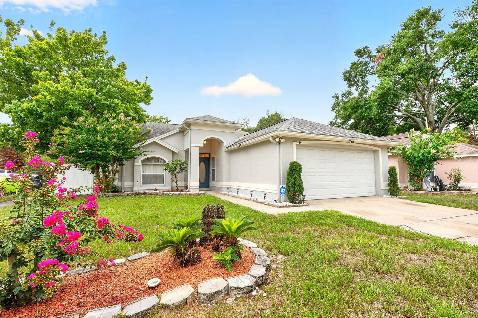 Great value, LOW HOA, and an established Apopka location – this 3-bedroom, 2-bath single-story home in Woodfield Oaks is full of potential for first-time buyers, investors, or anyone looking for a home they can make their own! Major updates include an UPDATED ROOF (2017), refreshed kitchen cabinetry and hardware, and STAINLESS STEEL APPLIANCES, giving you a great starting point while leaving room to add your personal style. Situated on a spacious CORNER LOT with mature landscaping, this home welcomes you with VAULTED CEILINGS and an open, light-filled layout featuring comfortable living and dining areas that flow seamlessly into the EAT-IN KITCHEN. Tile flooring extends throughout the main living spaces, while wood laminate flooring adds warmth to the guest bedrooms for easy everyday maintenance. The desirable SPLIT BEDROOM floor plan offers added privacy, with the PRIMARY SUITE ideally located, featuring a WALK-IN CLOSET and private en-suite bath. Two additional bedrooms and a full guest bath provide flexible space for family, guests, or a home office. Step outside to the SCREENED LANAI overlooking a fully FENCED BACKYARD, complete with a privacy fence and double gate for easy access – ideal for pets, play, gardening, or storing recreational equipment. The generous outdoor space is ready for weekend gatherings or future enhancements. Residents of Woodfield Oaks enjoy a convenient location with quick access to SR 414, US-441, Hiawassee Road, neighboring Orlando, and an abundance of shopping, dining, parks, and everyday conveniences. Whether you are searching for an affordable primary residence, your first home, or a smart investment opportunity, this well-located Apopka gem delivers outstanding value and endless possibilities. Call today to schedule a tour!