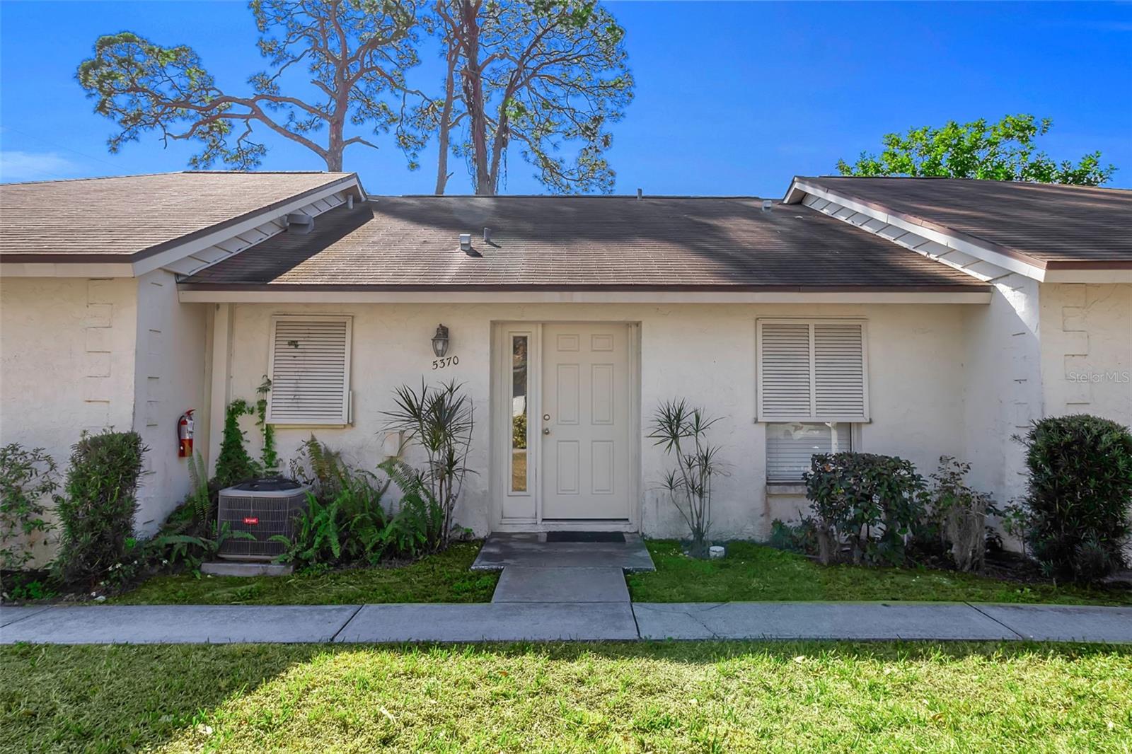 WELCOME to this beautifully maintained 2 bedroom, 2 bath villa located in the desirable Royal Palm Villas community of Sarasota!! As you enter, you are greeted by a fully UPDATED kitchen featuring granite countertops, stainless steel appliances, and ample cabinetry, seamlessly opening to the dining area and spacious living room which is perfect for both everyday living and entertaining. The living room offers a two panel sliding glass door that leads to the SCREENED, fully TILED lanai overlooking a PRIVATE backyard, creating a peaceful indoor-outdoor living experience. The primary suite features its own sliding doors to the lanai, an updated ENSUITE bathroom with a single vanity, and a walk-in tiled shower. A second bedroom and a full guest bathroom with a tub/shower combo provide comfortable accommodations for guests or family. Enjoy relaxing evenings in the screened lanai or take advantage of the community pool with covered seating, ideal for gathering with friends and neighbors. The home was renovated with hurricane resistant materials for added durability and peace of mind. Whether you’re searching for a full-time residence, seasonal retreat, or investment opportunity, this home is perfectly located near Sarasota-Bradenton International Airport, the Ringling Museum and College, the Van Wezel Performing Arts Hall, downtown Sarasota, fine dining, shopping, and the FAMOUS Gulf beaches...you truly can’t beat this location!! Don't wait to make this your HOME and begin your FLORIDA Lifestyle!