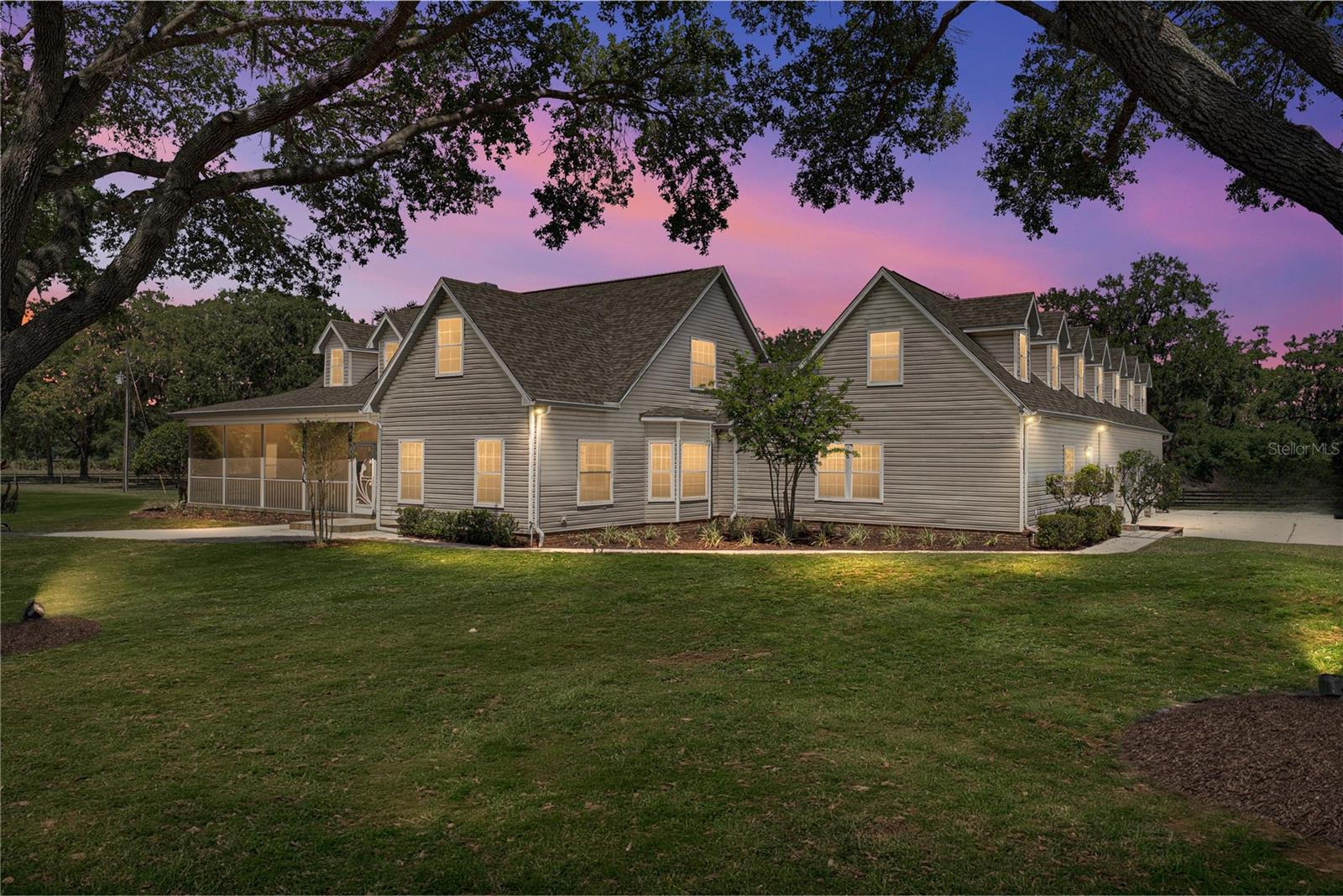 A true equestrian escape idyllically resting on nearly 43 acres in one of the few untouched areas of Dade City’s rolling hills. Three separate parcels combine together providing the opportunity for a family compound or sprawling farm life living. This 7 bedroom, 6.5 bath, 4 car garage pool home is accompanied by an expansive and well equipped 10 stall horse barn providing everything you need to move right in, bring your animals, and enjoy the surroundings. Mature landscaping and trees and a screened front porch overlooking the property offer a warm welcome. Inside, an expansive and flexible floor plan unfolds including a formal living and dining room, a family room, a well equipped chef's kitchen, a gym with a sauna, a laundry room/butlers pantry, and 7 generous bedrooms all perfectly placed throughout the residence. Head up to the second floor to discover a guest/in-law suite with a balcony overlooking the pool. Located on the opposite side of the master bedroom, this 2/2 suite has a spacious living room and kitchen area, and it could be closed off creating a separate entrance with a direct to the outside door located by the gym. The outdoor entertaining space is second to none featuring a tropical pavered pool deck with covered seating, a bar/grilling area, a pool and spa with rock and waterfall features, there is even a basketball court! Parking is no issue with an oversized 4 car garage a long driveway, and a huge parking pad. Bring your horses and other agricultural animals! This property is built for luxury rural living. With several cross fenced pastures and a barn already set up offering 10 stalls, a full bathroom, an office, laundry, tack room, wash room, a 9’x115’ 2nd floor loft, and a center aisle with barn doors on both ends. This isn't just a house- this is the epitome of an Equestrian Paradise.