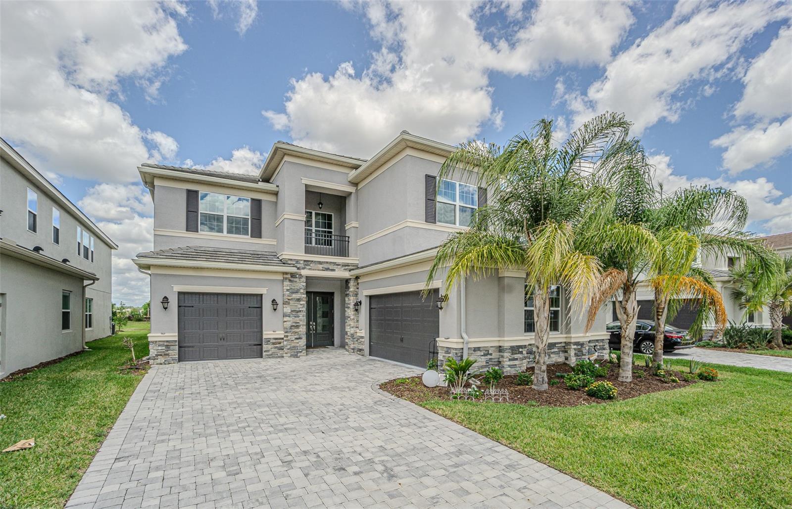Available July 1st! Situated against a serene nature view, this 2023 GL Homes masterpiece in Winding Ridge represents the peak of modern Florida luxury. The home spans over 4,100 square feet and begins with a grand two-story foyer that flows into an expansive Great Room, creating a space that feels both monumental and welcoming. The chef-inspired gourmet kitchen serves as the home’s functional anchor, featuring professional-grade stainless appliances, a gas cooktop, and a sprawling quartz island that unites the dining and family areas. A dedicated game room sits adjacent to the main living space, offering a versatile retreat that keeps you connected to the property’s natural views through floor-to-ceiling glass sliders.    Outdoor living is prioritized through a massive, screened-in patio that functions as a seamless extension of the interior. The custom-designed outdoor kitchen allows for high-end entertaining against a backdrop of the preserve and water, providing a private sanctuary for evening relaxation. On the second level, the layout focuses on privacy and personal space, centered around a large loft that creates a natural buffer between the secondary en-suite bedrooms and the owner’s retreat. This primary suite is a true sanctuary, complete with dual walk-in closets and a spa-style bath featuring a deep soaking tub and a generous walk-in shower.    The property is built for long-term peace of mind, equipped with full hurricane-impact windows and doors, a durable tile roof, and a six-car brick-paver driveway. Life in Winding Ridge is defined by effortless maintenance, as the HOA handles all landscaping, fertilization, and exterior pest control. This allows for more time to enjoy the resort-caliber clubhouse, sports courts, and a full-time activities coordinator, all while staying perfectly positioned near Wesley Chapel’s top-rated schools and premier shopping districts. The result is a home that amplifies your hosting potential, secures your lifestyle with reinforced construction, and offloads the stress of exterior upkeep.