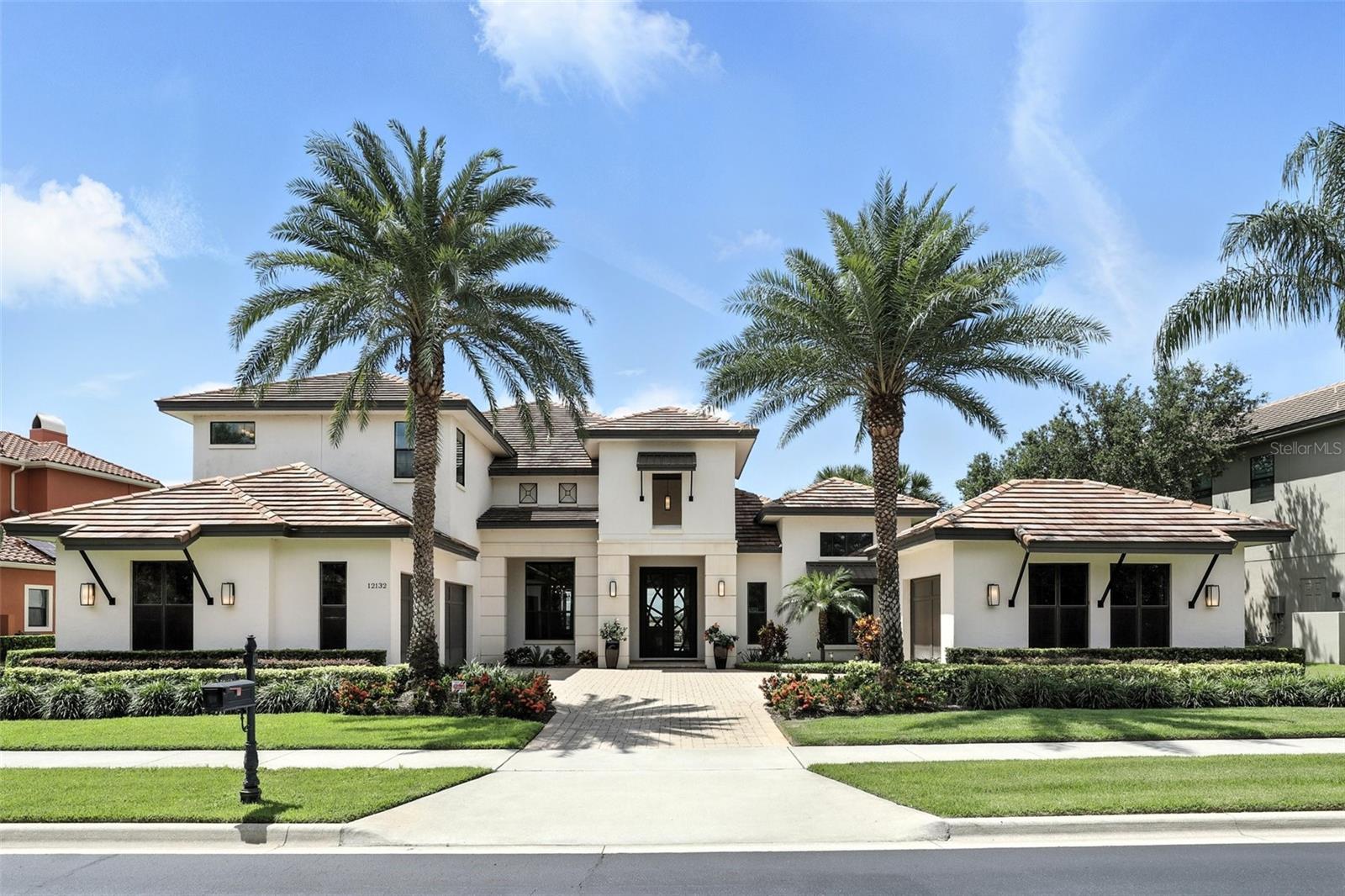 Experience the essence of luxury lakefront living in this stunning contemporary Mediterranean estate, ideally positioned on Lake Burden within the exclusive gated community of Casa Del Lago in Windermere. This elegant two-story residence combines refined design, functionality, and breathtaking panoramic lake views throughout.
The gourmet kitchen features custom dark cabinetry, quartz countertops, a designer mosaic backsplash, pendant lighting, and top-of-the-line stainless-steel appliances. The primary suite is a serene retreat showcasing peaceful lake views, a spa-inspired bathroom with a freestanding soaking tub, dual vanities, and a custom-designed walk-in closet.
This remarkable home also includes a fully equipped theater room, a complete gym setup, multiple TVs, and select designer furniture pieces in the dining room, living room, and office, along with all chandeliers and lighting fixtures.
Outdoors, enjoy a resort-style pool, spacious travertine patio, and a private dock with lifts for both a Yamaha boat and Jet Ski, which are included in the sale for your convenience.
With its three-car garage, lush landscaping, and proximity to fine dining, golf, and top-rated schools, this residence exemplifies modern sophistication and lakefront elegance in Windermere.