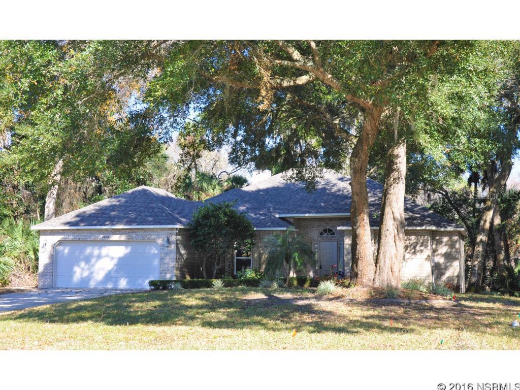 This beautifully remodeled 2 story brick home overlooks magnificent Florida nature in all it's glory with amazing views looking East toward Spruce Creek. You will love the spacious open living area with vaulted ceilings, recessed lighting and wood burning Fireplace for warmth and comfort. The kitchen boasts fine wood cabinets, stainless appliances and granite countertops with an island cooktop. There is plenty of counter bar style seating along with ample eat-in kitchen dining area. There are 3 spacious bedrooms and 2 nicely upgraded baths. All rooms have newly upgraded flooring. You will love the high ceilings throughout this home. The laundry room is inside just off the kitchen area. The Master suite is very large with lots of closet spaces and private entrance bath area. The second and third bedrooms both have their own private entrance into the bathroom with walk in shower and dbl sink areas. The beautifully appointed downstairs area can be anything you want...A private gym, your personal man cave, pool table room, movie/TV room with leather pit group, bar/party area, private office space, games or crafts space, extra sleeping area, etc. There is an additional room for storage or more living/office/computer space. The large 2 car garage has additional storage space both above and in the closet spaces. Privacy fenced but lot is deeper than it appears. Endless possibilities in this very contemporary and comfortable home close to shopping and restaurants. ;Water: City
