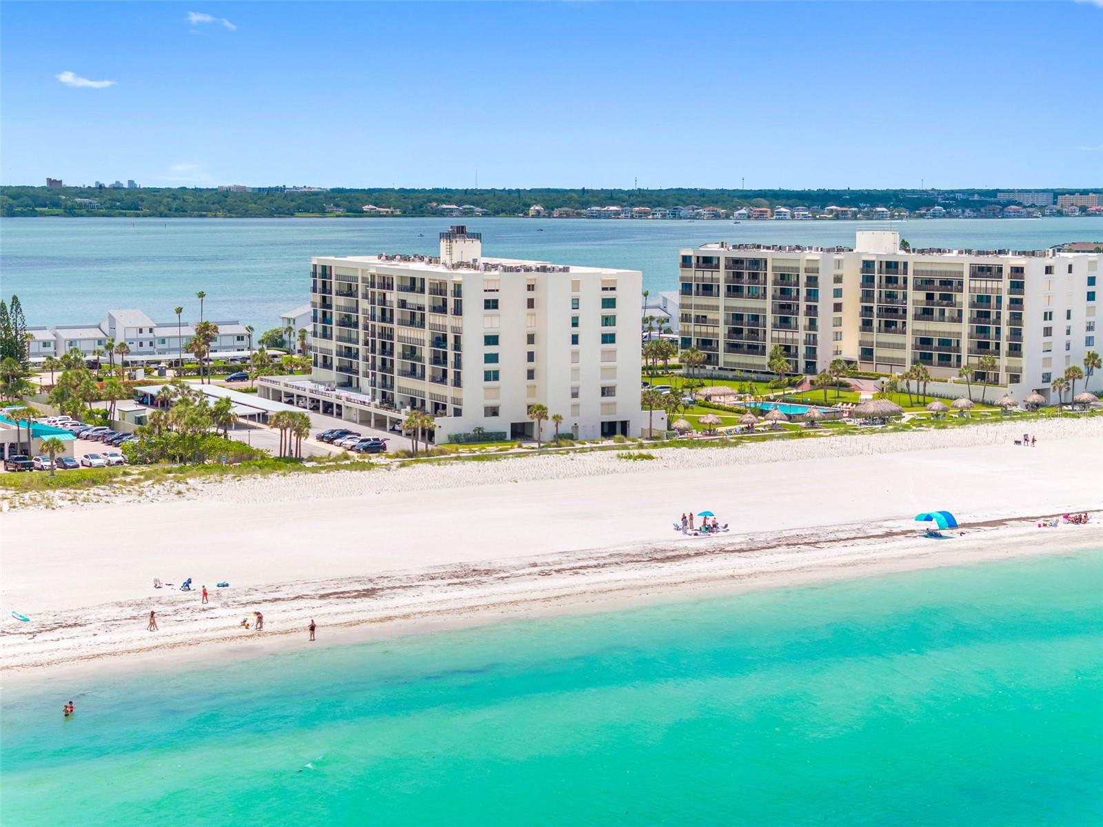 Virtually Staged. Panoramic ocean vistas and modern luxury blend seamlessly in this stunning beachfront property. Situated in a prime oceanfront location in the heart of Sand Key, this rarely available NW corner unit offers sweeping UNOBSTRUCTED views of the beach and Gulf that stretch all the way to Honeymoon Island. No expense was spared in this impeccable renovation. High-end touches include exquisite porcelain tile flooring that runs throughout, custom 5-inch base boards, new interior doors, ambient cove lighting, and upgraded floor to ceiling sliding doors that access a 23ft. balcony with incredible water views. All doors are protected by storm shutters. West facing windows provide direct views of the Gulf and abundant natural light. The designer Chef's kitchen is a masterpiece, perfectly configured for entertaining and maximum functionality. Custom features include shaker wood cabinetry with soft-close drawers, GORGEOUS Calcutta Cielo quartz countertop, custom ambient lighting, and top of the line stainless-steel Bosch appliances. There is even a West facing window with an ocean view for the chef! Both bedrooms are spacious with sliding doors that access the balcony and generous closet space that includes built-in organizers. The owner's retreat adds dual closets and ensuite bath with dual vanities. Luxurious spa-inspired baths feature lighted high-tech anti-fog mirrors, quartz countertops, and resort-style showers that include upgraded fixtures and dual shower heads. This property also comes with a premium under-building parking space and storage locker for your beach toys! South Beach I is a vibrant gated community that is perfectly positioned on one of the most pristine beaches that you will find anywhere. Experience unforgettable sunsets from the Tiki Huts and swim in the heated resort-style pool that overlooks the Gulf. Other amenities include a fitness room, pool baths, outdoor showers, onsite manager, and club room for social events. Close to everything including excellent restaurants, shops, entertainment, and the Jolley Trolley! Call now to schedule your tour. Virtual tours are also available.