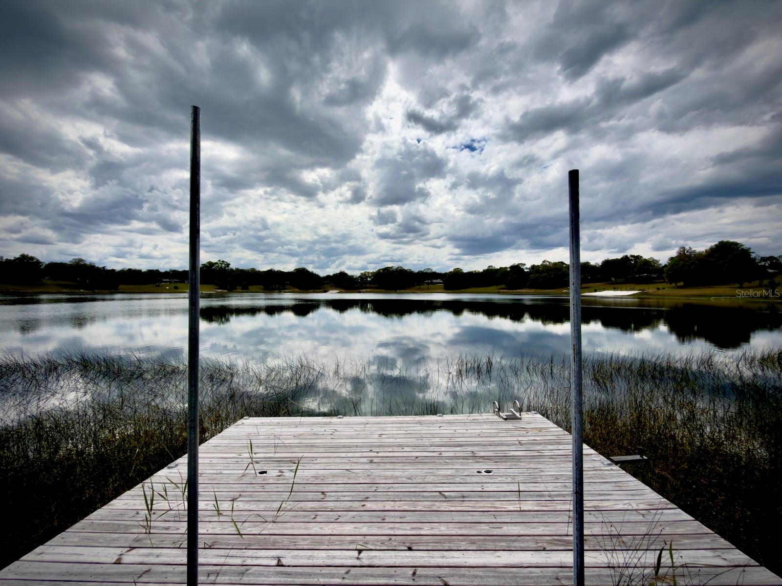 Waterfront acreage with rare multi parcel flexibility on Lake Coronado. This 6.91 acre property in Marion County includes two separate parcels, opening the door to opportunities you simply do not find often. Build your private lakefront home on the front parcel while utilizing the additional 3.47 acre rear parcel for a second home, guest house, workshop, or even agricultural use if desired. With paved road access and a peaceful setting surrounding Lake Coronado, this property offers the ideal blend of privacy, usability, and long term upside. Conveniently located just a short drive from Lake Weir and The Villages, you get the benefit of quiet rural living without sacrificing access to shopping, dining, and everyday essentials. Zoned for residential and agricultural use, you will have the freedom to create anything from a secluded estate to a multi structure homestead. Whether you are looking to build now or secure land with future potential, this is a unique chance to own versatile waterfront acreage in one of Marion County’s most naturally beautiful settings.