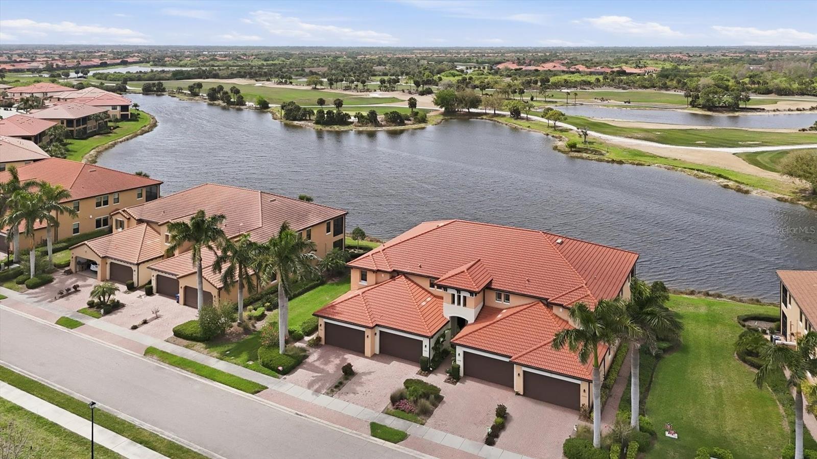 MAGNIFICENT LAKE AND GOLF COURSE VIEWS AND SPECTACULAR SUNSETS! This 2nd floor condo offers tons of space with 3BD/2BA/DEN/2CG. COMES WITH 2 GOLF MEMBERSHIPS.  Bright and Cheery open Great room floor plan is flooded with light from the South Western facing lanai. ONE OF THE BEST VIEWS IN THE NEIGHBORHOOD. LUXURY VINYL floors throughout the main area and den.  Kitchen has GORGEOUS GRANITE counter tops, STAINLESS STEEL applicances, TILE BACKSPLASH, EXTRA RECESSED lighting, PENDANT lights, and LARGE ISLAND.  Open to the living area and dining space, all with VIEWS.  LONG LANAI for sitting outside in the Florida weather.  Plenty of space for table and sitting area. SEPARATE DEN with FRENCH DOORS.  CUSTOM DESIGNED window treatments and shades.  UPDATED FIXTURES AND FANS.  Spacious master bedroom with en suite bath offering dual sinks, walk in closet, walk in shower with tile to ceiling, seamless glass doors, Listello decor, and dual rain shower heads. Two guest bedrooms at other end of home for privacy share a guest bath.  HURRICANE WINDOWS/SLIDERS. LOCATED ON A QUIET CUL DE SAC with little drive through traffic and no condos or homes across the street in front either.  MAKE YOUR ESCAPE FROM THE WINTER BLUES TODAY!!  COME FIND YOUR FLORIDA LIFESTYLE!  Sarasota National is a marvelous community with over 1300 acres designated for preservation, conservation, lakes, and open space with amazing views, Proclaimed as an Audubon International Certified Sanctuary, making it the most gorgeous and enjoyable golf course to play at in the area. Offering resort style amenities with huge resort style pool and spa,Tiki Bar to serve refreshing drinks and a bite of lunch, tennis courts, pickle ball, Bocce courts, coffee lounge/library/card room/meeting place, 7000 sq ft fitness facilities offering classes and day spa, and a 30,000 sq ft Clubhouse with dining and spectacular views. 18 Hole championship golf course surrounded by native wetlands and preserves provides an exhilarating and dramatic back drop for your golfing adventure. Minutes away from the new Wellen Park shopping area and Atlanta Braves stadium. Venice Beach and Venice Downtown are just a short drive. Your choice of restaurants and outdoor activities await. Come find YOUR Florida lifestyle TODAY and Live everyday like your on vacation!