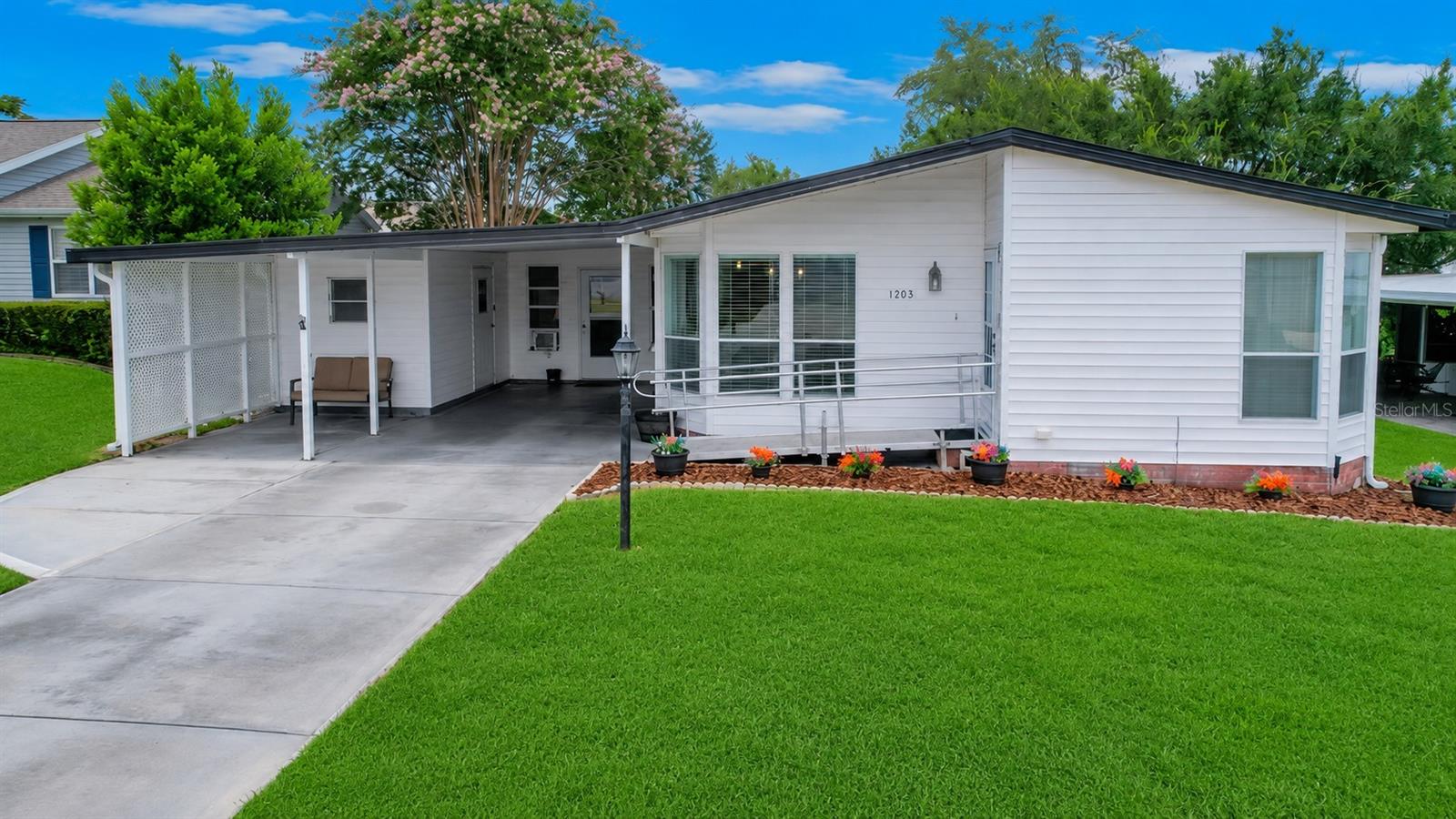 Welcome to this charming 2-bedroom, 2-bathroom home with a spacious bonus room and NO BOND, ideally located just one mile from Spanish Springs. Step inside to discover luxury vinyl plank flooring throughout the main living areas, an abundance of natural light, and a neutral color palette that creates a bright, inviting atmosphere. The kitchen features white cabinetry, ample counter space, and a sunny breakfast nook surrounded by windows. The spacious primary suite offers a large walk-in closet and an en suite bathroom. An inside laundry closet adds everyday convenience. The expansive 15' x 19' bonus room provides endless possibilities and is perfect for entertaining, a hobby room, home office, or additional guest space. Major updates include a new roof (2024), tankless water heater (2019), and HVAC system (2017), giving added peace of mind. The carport offers room for both a vehicle and a golf cart, while the attached oversized storage room provides plenty of space for tools, seasonal décor, or extra belongings. Conveniently located near shopping, restaurants, medical offices, and all the entertainment, dining, and activities of Spanish Springs, this home truly offers the best of The Villages lifestyle.