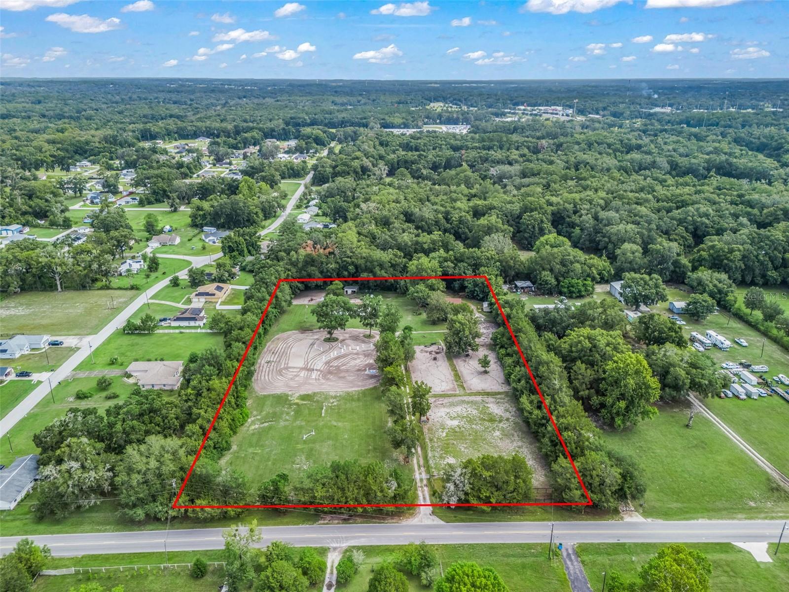 Just 6.8 miles from the World Equestrian Center!! This exceptional 5-acre equestrian property offers the perfect blend of functionality, convenience, and opportunity. Designed for horse enthusiasts and professionals alike, the working farm features an 8-stall center-aisle barn complete with stall mats, a large dirt arena that can easily be adapted for any riding discipline, and an additional 2-stall shed-row barn for extra flexibility. The spacious 3-bedroom, 2-bathroom manufactured home offers comfortable country living with walk-in closets, a dedicated laundry room, and elegant coffered ceilings. Enjoy the peace and privacy of a natural tree buffer on three sides of the property, creating a secluded setting while still being just minutes from the World Equestrian Center. The property is fully fenced and cross-fenced, providing excellent pasture management and room for horses to thrive. The property is fully fenced and cross-fenced, providing excellent pasture management and room for horses to thrive. Whether you’re looking to establish your own equine business, create a private training facility, or invest in a highly desirable rental property near the World Equestrian Center, this farm offers endless possibilities. Bring your vision and make this versatile equestrian gem your own!