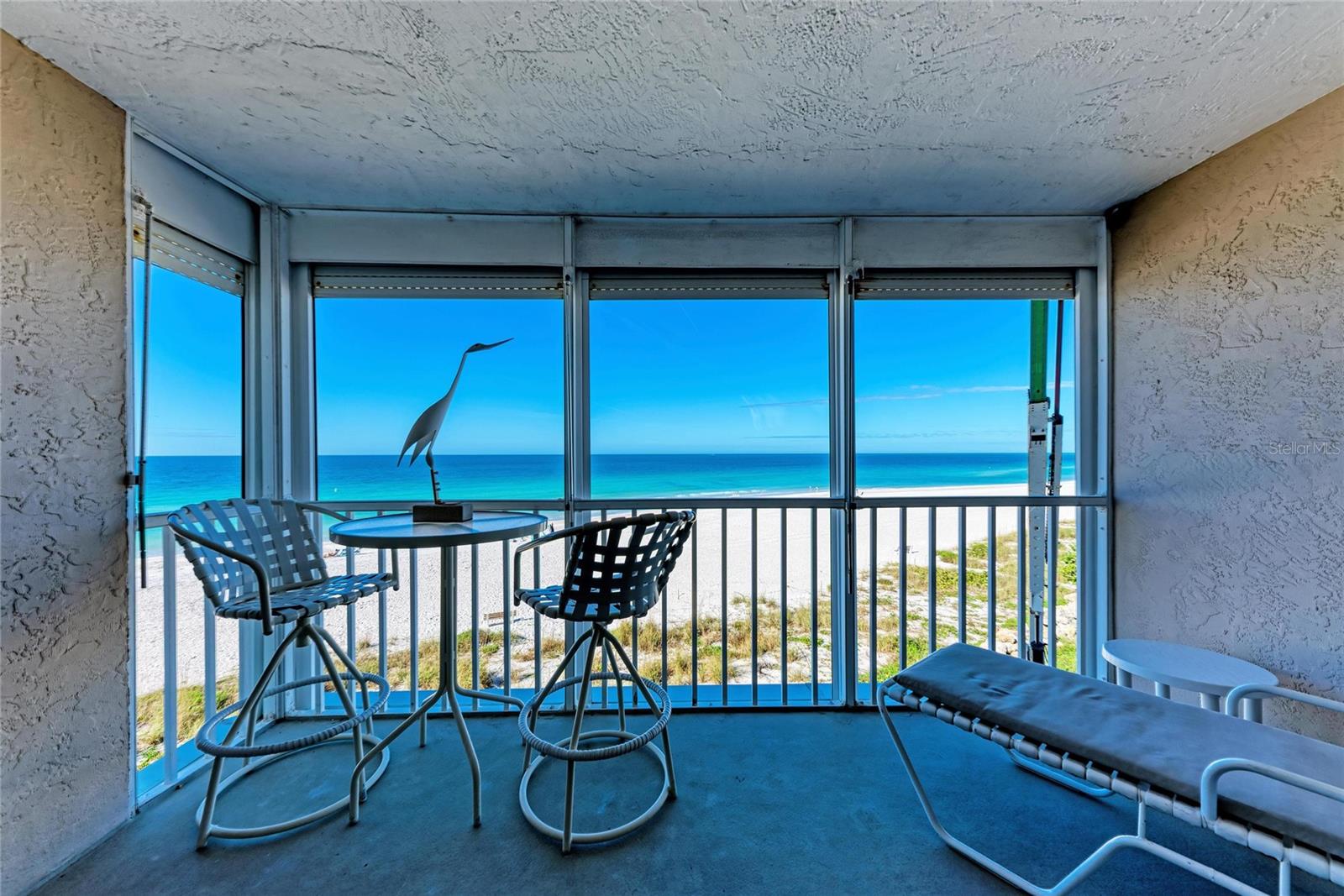 GULF FRONT - Spacious and Beautifully Maintained and Renovated 1 Bedroom/1 Bath Condo in the Heart of Holmes Beach.  Breathtaking Gulf Views to behold from every room.  The kitchen, windows and sliding doors have been updated and the AC was replaced in 2025.  This unit features a covered, open balcony allowing for your own Private Outdoor Space while relishing in the balmy Gulf breezes.  Commodious Open living/dining area is painted in calm, neutral colors and ceramic tile flows throughout.  The bedroom features full gulf views, a large walk-in closet and ensuite bath with separate vanity area and combination tub/shower.  The updated kitchen provides plentiful and aesthetic cabinetry, a closet pantry, newer appliances, desk area and Washer and Dryer. Martinique South offers a Gulf side pool, tennis/pickle ball courts, an elevator, secure entrance, large Community living space with full Gulf Views,  a complete kitchen, bathrooms, and outdoor covered patio.  The Community Room is ideal for parties and large gatherings.  Pride of ownership shines in this community where friends are neighbors and neighbors are friends.  This lovely unit is offered turn-key furnished, with room for your personal touches as well as a carport and storage room.  Located within walking distance of Holmes Beach amenities.  Magnificent sunsets, strolls along the white sand beach, passing dolphins, the cry of the seabirds and the comforting sound of the surf await...