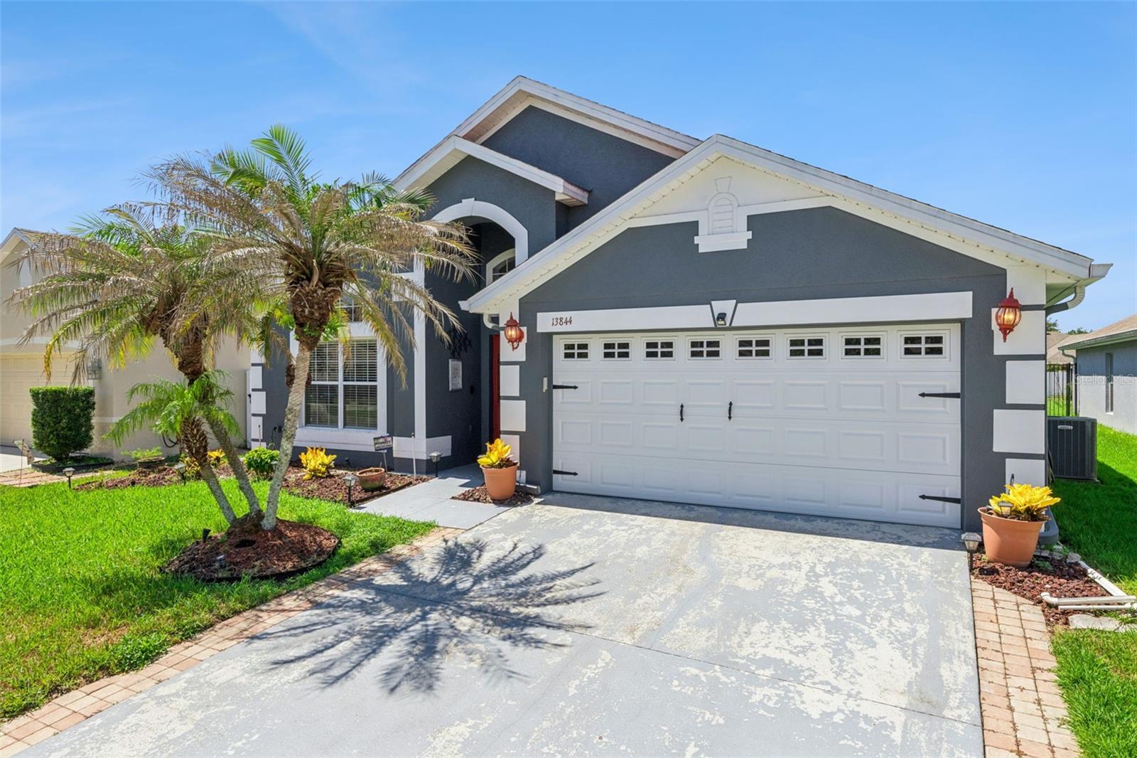 Located within the beautiful gated community of Avalon Lakes Village in the heart of Avalon Park, this move-in-ready home combines modern updates, spacious living, and an unbeatable East Orlando location! With a low HOA and resort-style amenities including a clubhouse, community pool, tennis courts, playgrounds, parks, sidewalks, and gated security, you'll enjoy the lifestyle as much as the home itself.

Inside, you'll find soaring vaulted ceilings, abundant natural light, and an open-concept floor plan that creates an inviting space for everyday living and entertaining. The home features 4 bedrooms, 2 beautifully renovated bathrooms, updated countertops throughout, custom built-ins in the primary closet, a 2019 HVAC system, roof replacement in 2018, and fresh exterior paint for added peace of mind.

A standout feature is the screen-enclosed lanai converted into a glass-enclosed Florida room, creating the perfect flex space for relaxing, entertaining, or enjoying Florida's year-round sunshine.

Beyond the gates, you'll love being just minutes from Downtown Avalon Park, known for its charming restaurants, coffee shops, boutiques, breweries, farmers markets, and year-round community events that create the neighborhood's signature small-town charm. Conveniently located near Waterford Lakes Town Center, UCF, Research Park, SR-408, SR-417, Orlando International Airport, Lake Nona Medical City, and Downtown Orlando, this home provides exceptional access to shopping, dining, major employers, and all that makes Central Florida one of the most desirable places to live!

If you've been searching for an updated home in one of East Orlando's most desirable gated communities, 13844 Mirror Lake Drive is where comfort, convenience, and community come together.
