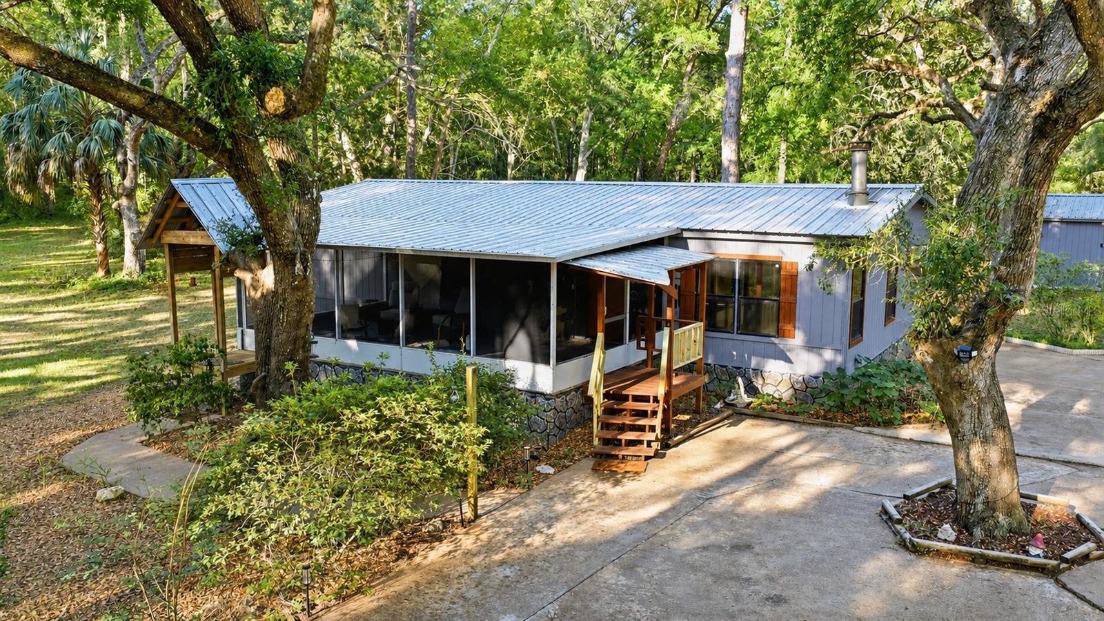 **PRICE IMPROVEMENT – PRICED BELOW APPRAISED VALUE!**

Escape to the peaceful countryside of Williston with this unique property situated on **8.7 acres** of beautiful North Central Florida land. Conveniently located between Gainesville and Ocala, you'll enjoy the privacy of rural living without sacrificing access to shopping, dining, and everyday conveniences.

This charming home features beautiful flooring, a cozy wood-burning fireplace, and large windows that fill the living spaces with natural light while showcasing scenic views of the property. A private mother-in-law suite with its own bedroom and bathroom offers excellent flexibility for guests, extended family, or multi-generational living.

Outside, you'll find plenty of room to enjoy the Florida lifestyle, including an above-ground pool, multiple storage sheds, and a workshop ideal for hobbies, equipment storage, or agricultural use. Recent improvements include updated plumbing, a new electrical panel, engineer certification for tie-downs, and leveling, providing added peace of mind for the next owner.

With 8.7 acres of land, numerous updates, versatile outbuildings, and a price below appraised value**, this property offers exceptional value and endless possibilities. Don't miss your opportunity to own a private country retreat with room to live, work, and play. Schedule your showing today!



Please submit all offers on Florida Bar “AS IS” Contract with proof of funds or pre-approval attached.

Additional parcel included in sale:1826800000

Mounting bracket will convey; TV will not convey. All window rods will convey, excluding the valence in the secondary bedroom. Ring system does not convey. Washer and dryer do not convey. Select furniture pieces are available for purchase separately at an additional cost.
