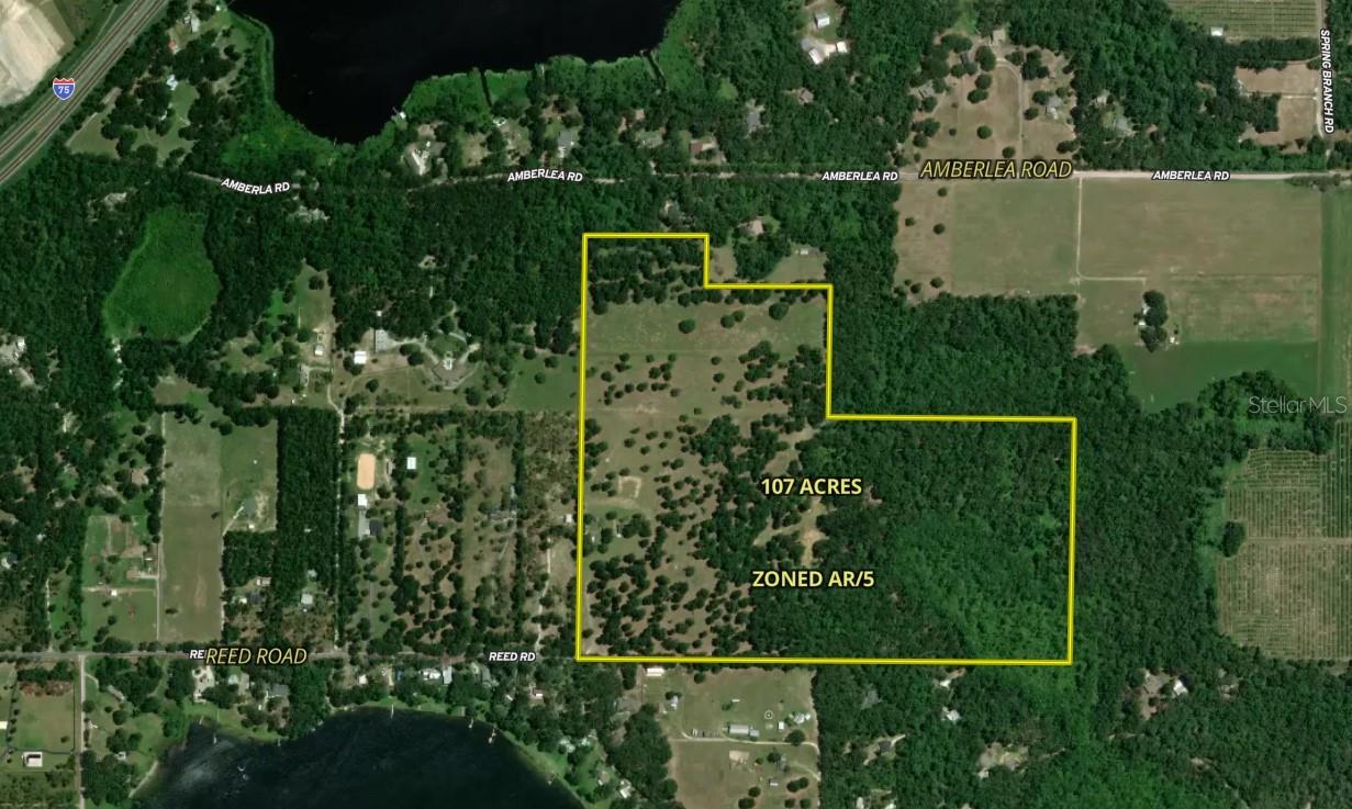 31501 REED ROAD! One of the last massive pieces of pristine, untouched vacant land in all of Pasco County. This unbelievably rare, quiet and perhaps unearthly piece of property is now on the market for purchase. Three parcels (Parcel # 1: 15-24-20-0000-00100-0093, Parcel # 2: 15-24-20-0000-00100-0094 and Parcel # 3: 15-24-20-0000-00100-0170) combine for a total of 107 acres. This land features rolling hills, open pastures, deep woods, and spring-fed seasonal creeks, in addition to having one of the highest elevations in all of Central Florida. Situated at the very end of a picturesque and quiet newly paved road, sits the main entrance to this massive property.

This one-of-a-kind location and expansive property would suit a multitude of buyers. Already situated as a working ranch, this property is ready for the next owner who dreams of endless pastures and 100-plus-year-old Oak Trees; they would be in heaven! Not to mention the endless wildlife that adds to this land's extreme beauty. Hawks, Osprey, and Eagles are a common sight, while Foxes, Deer and the prized Osceola Turkey make routine appearances. This is a playground for nature lovers and avid sportsmen alike! In addition to all this beauty the property could easily be upgraded into a charming country estate or potentially a private family compound. Multiple family dwellings, barns, trails, etc.... the opportunities for one's dreams are endless!  

Equally intriguing and rare in itself, these 107 acres are zoned AR-5, meaning a savvy investor or developer could build out an exclusive community consisting of several exquisite, secluded homesteads (approximately 18 homes based on buildable acreage). With direct access at the end of Reed Road, and an easement connecting Amberlea Road to the far north parcel, this "would be" exclusive community, is easily accessed from multiple points of entry and convenient in multiple directions. Such a potential premiere community would be a home run for any developer's portfolio.

As it stands, the current ranch and acreage are completely fenced and sectioned off into multiple pastures. Turnkey ready from day one for any and all livestock or animals. This property currently holds an agricultural exemption (greenbelt) and would certainly be a candidate for future exemption following all requirements. It is equipped with a fully functioning well (estimated to be over 200 ft deep), powered by both a windmill and electric pump. The property includes two separate 200 amp service feeds and is set up for two electrical meters. Currently, included on site is a 48x30 covered open pole barn, equipped with an RV pad, deck and power (the RV in the photos does not convey). Also included is a fully enclosed shed, large enough for your UTV, which also has power and air conditioning.

Don't miss your opportunity to breathe in the sweet pasture breezes or cast your eyes upon towering grandfather oaks. Come see this one-of-a-kind property today—a sincere rarity in all of Florida these days. Located just 10 minutes off I-75, this property is minutes from the quaint and folksy towns of Dade City and Brooksville. While also in near proximity to the bustling cities of Tampa/St. Pete (45 minutes) and their beautiful beaches, Ocala (60 minutes) and its world-class equestrian offerings or Orlando (90 minutes), the theme park capital of the world. This enchanting piece of land will certainly be a favorite among many, make it a priority to tour it today!
