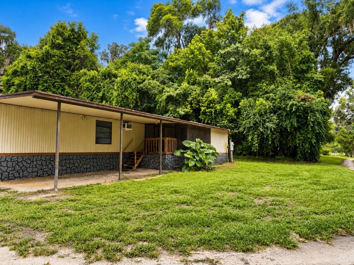 Potential income-producing investment opportunity in Ocala! Situated on over half an acre, this multifamily property features two mobile homes, with the front residence offering an attached studio suite with private entrance, kitchenette, shower, deck area, and car port. Seller reports potential rental income of approximately $3,000 a month when fully occupied. Property includes a shared well, separate septic systems, multiple carports, and ample outdoor space. Ideal for investors, multigenerational living, or owner-occupants seeking additional income potential. Conveniently located near shopping, dining, and major roadways. Buyer to verify all measurements, zoning, rental use, financials, and intended use. No HOA, corner lot.
