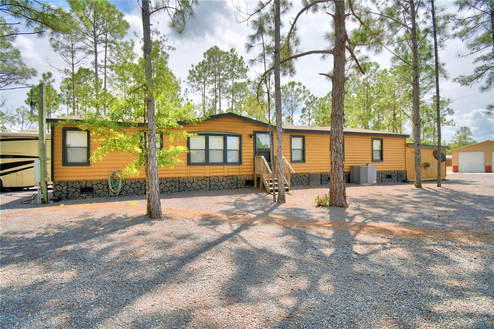 4 Bedroom, 3 Bath Manufactured Home on Over 2 Acres – Fully Renovated & Move-In Ready!Located next to River Ranch, this beautifully updated 4-bedroom, 3-bath manufactured home offers the perfect blend of modern upgrades, wide-open space, and peaceful country living. Situated on over 2 acres, this property is ideal for full-time living, weekend retreats, entertaining, or even an income-producing investment opportunity.From the moment you arrive, you’ll appreciate the newly laid gravel driveway and fully fenced perimeter with brand-new gates, offering both curb appeal and privacy. The land has been raised and flood-proofed, providing added peace of mind.Inside, the home has been completely renovated with new flooring throughout, updated light fixtures, new interior doors, and a stunning kitchen featuring stone countertops and brand-new appliances. The spacious layout comfortably accommodates family and guests, and the log wood furniture conveys — including 2 king beds and 4 bunk beds, with TVs in every room.Major system upgrades include:New AC system with all new ductworkNew septic system and updated plumbingNew tie-downs for added structural stabilityBrand-new roofNew water filtration systemStep outside and you’ll find even more to love:Large new metal building garage for vehicles, toys, or storageTwo RV hookups with 200-amp service eachFire pit area perfect for relaxing evenings under the starsCamera surveillance system and floodlights for enhanced securityWhether you're looking for a spacious homestead, a retreat near River Ranch, or a turnkey property ready to enjoy immediately, this one checks all the boxes.Schedule your private showing today — properties with this level of upgrades and acreage don’t last long!