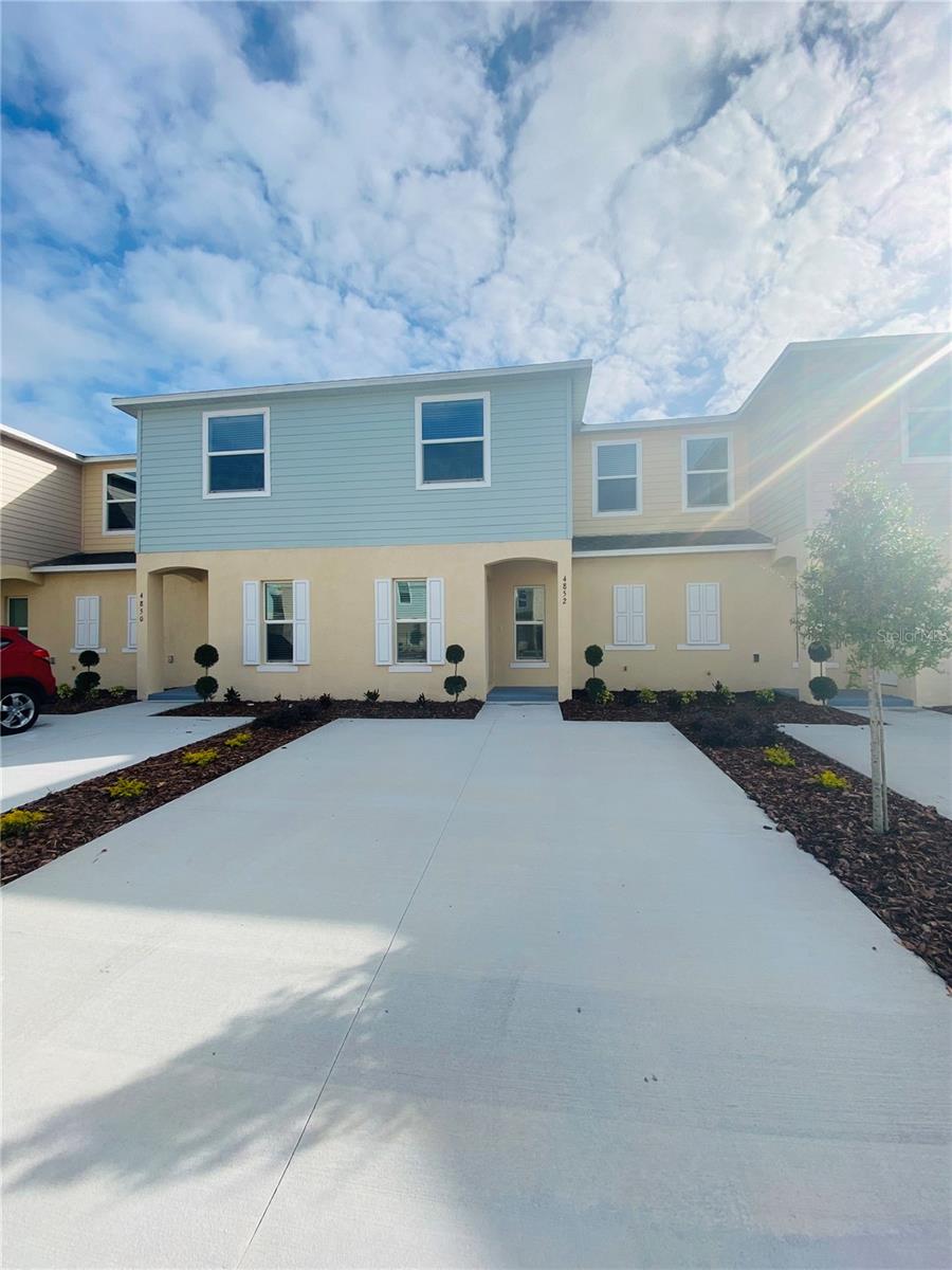 This two-story, 3 bedroom, 2.5 bathroom townhouse in the gated community of Fiesta Key. The first floor features an open floor plan with tile flooring throughout, connecting the living room and dining area to the kitchen. The kitchen includes granite countertops, an island with seating space, wood cabinets, and stainless steel appliances. A screened porch with a storage room is locate off the back. All bedrooms and the laundry area are located on the second floor. The primary bedroom includes a walk-in closet and a private bathroom with a double  sink granite vanity and a shower. The other two bedrooms share a second full bathroom, which also features a double -sink granite vanity, a tub, and a linen closet. Fiesta Key community amenities includes a fitness center, two pools, and a tennis court. The property is locate minutes away from Disney parks, Universal Studios, shopping centers, dining, schools, making a great option for a primary residence, vacation home, or investment property.