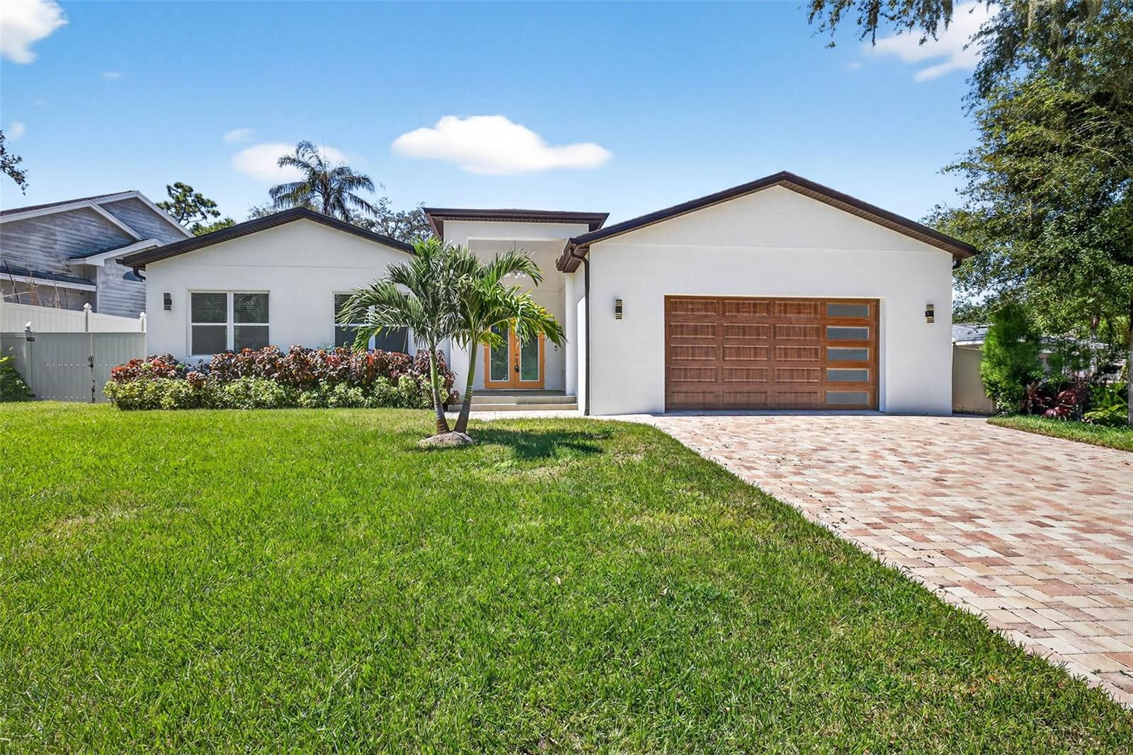 One or more photo(s) has been virtually staged. Welcome to your completely, rebuilt dream home in Temple Terrace! With views of the 18th Green of The Temple Terrace Golf Course, this stunning homes offers 4 bedrooms, 3.5 bathrooms, and nearly 3,000 sqft of thoughtfully designed living space. From the moment you step inside, you’ll be impressed by the sleek marble tile floors flowing throughout the home and the abundance of natural light.
The heart of the home is the bright, modern kitchen featuring a show-stopping waterfall island, unique marble-look counters with bold black and gray veining, stainless steel appliances, and extensive cabinetry. A spacious storage room off the kitchen could double as a walk-in pantry. The kitchen opens to a dining area and expansive living room with dual sliding doors leading to the covered patio and large fenced backyard—ideal for entertaining or everyday living.
The main-level half bath is conveniently located near the common spaces. The luxurious primary suite boasts a spa-inspired bathroom with a walk-in shower and a custom-designed walk-in closet. Bedroom 2 could serve as a second primary suite as it includes dual closets and its own en-suite bath with a double vanity and walk-in shower. Right down the hall are Bedrooms 3 and 4 and a beautifully appointed full bath.
Additional highlights include a mudroom entry, an indoor laundry room with sink and storage, and an oversized 2-car garage. The spacious lot is almost 1/3 of an acre and with a flat and cleared backyard there's plenty of room to add a pool, outdoor kitchen, playset and more. 
NO HOA or CDD! Located in the golf-cart-friendly community of Temple Terrace, this home is brand new and ready for its first owners. Don’t miss this rare opportunity to own a stylish, spacious home in a prime location!