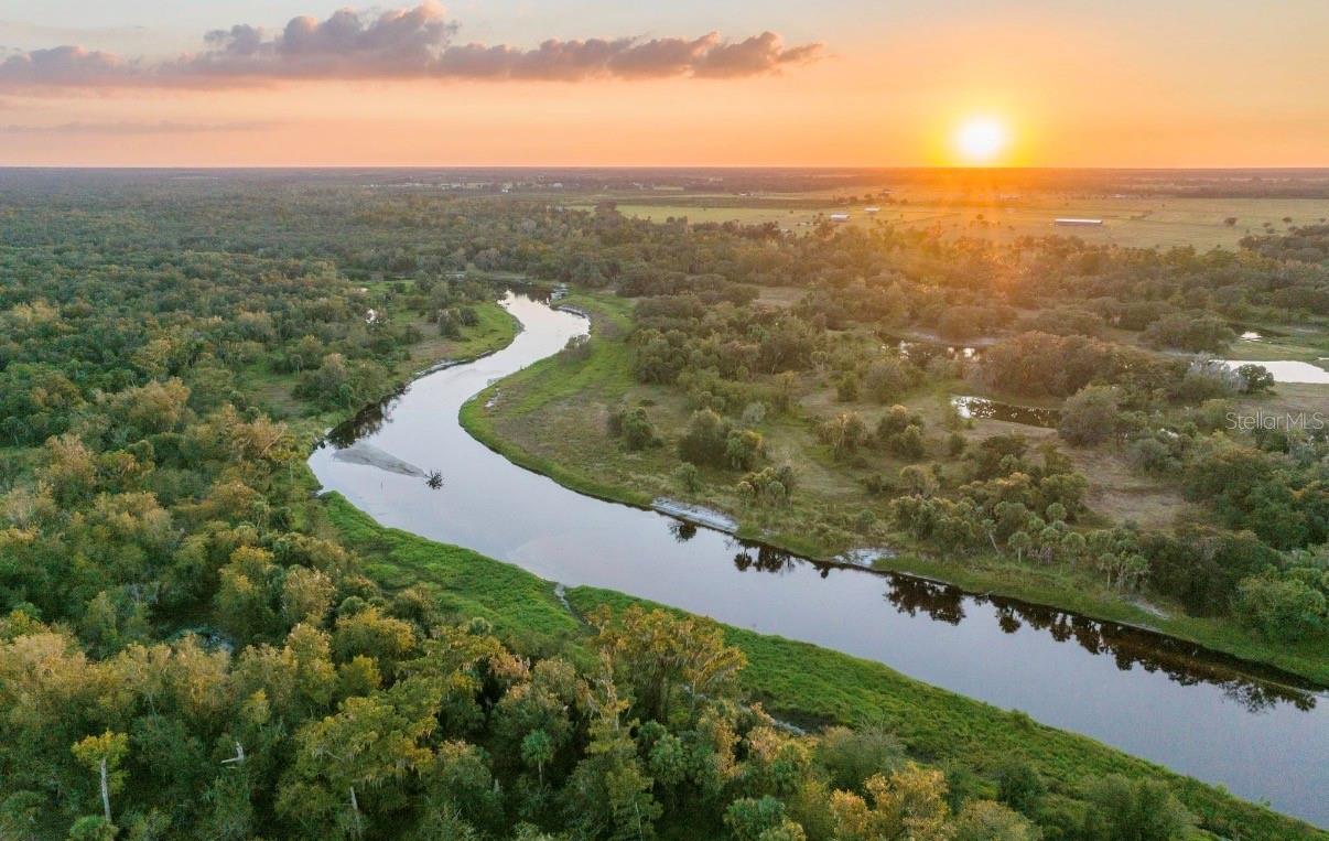 310± acres with approximately 1.25 miles (over one mile) of Peace River frontage, this offering provides a rare chance to acquire a significant Florida property. Private, expansive, and naturally beautiful, the property delivers a sense of space and exclusivity that is becoming increasingly uncommon and rare to find in Florida today.

Property is pending a conservation easement. A recent survey completed less than one year ago confirms the acreage. The conservation easement allows for the construction of one single-family residence up to 5,000 square feet and two barns not to exceed 2,000 square feet each.

The property offers exceptional recreational use with abundant wildlife, including whitetail deer, Osceola turkeys, axis deer, and wild hogs, providing outstanding hunting opportunities. Significant improvements are currently underway, including new ponds being dug, underbrushing and clearing, pasture improvements, and new fencing.

An additional adjoining 700± acres bordering the south side of the property may be available for purchase. This adjoining tract is conserved and allows for two additional single-family residences up to 5,000 square feet each, four barns, and up to 10,000 square feet of agricultural buildings, with approximately seven miles of Peace River frontage and three miles of Joshua Creek.

Schedule your private showing today.