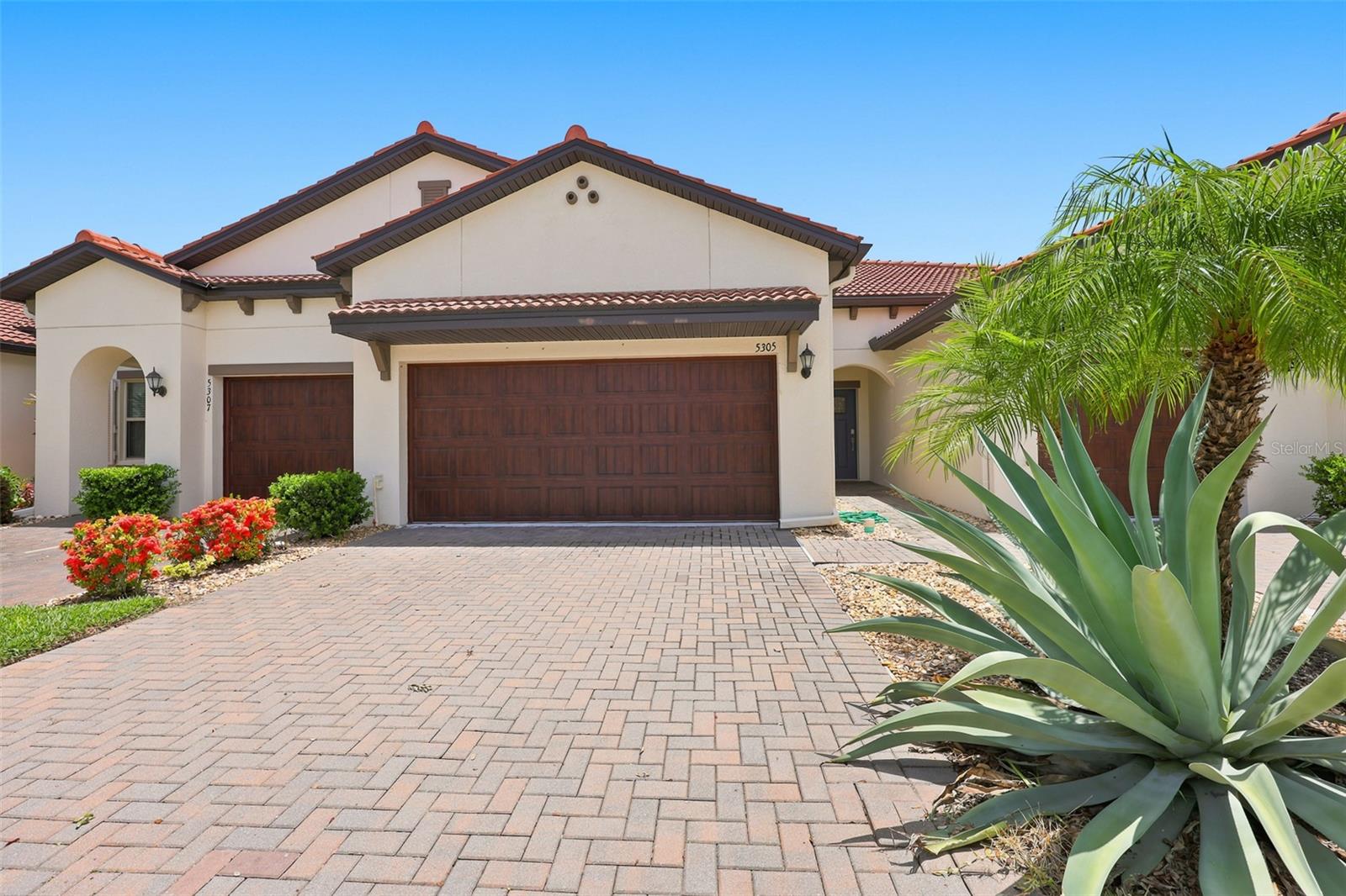 Welcome to Paradise!  This 2 bedroom/ 2.5 bathroom townhouse villa has a 2 car garage PLUS a golf cart garage in the very desirable active adult community of Medley in South Shore Bay. The kitchen features all newer appliances (2023), including an induction stove, new large kitchen sink, and a new washer and dryer. The island is big enough to accommodate several bar stools and opens to a dining area for entertaining larger crowds. New blinds adorn the sliders that lead out a screened lanai, where you can enjoy the secluded and scenic wooded view. Upstairs is a loft living room, 2nd bedroom and bathroom, just perfect for guests to enjoy privacy. Not only is the home a very short walk away from the resort-style pool and clubhouse, but it is also on a quiet, dead-end street.  Other multiple upgrades include a water softener/purification system, a phantom screen front door, ceiling fans, a paver pathway that leads to the golf cart garage, rain gutters, and tons of extra storage space in the garage. Monthly fees include lawn care, outside water for irrigation, outside maintenance and insurance, roof, internet, cable, gated security, clubhouse, pool, fitness center, and lagoon. Southshore Bay Medley offers an amazing retirement lifestyle you've worked so hard for and dreamed of for years. Meet new friends over a drink by the resort-style pool, land-scaped with tropical palm trees. Vacation is every day here! Your very own clubhouse has a cafe with indoor and outdoor dining, full bar service, card room, fitness center, pool table, and pickleball courts. The beautiful new ballroom is perfect for organized parties, dances with live music or a DJ, comedy shows, and more. In addition to everything Medley has to offer, you will also have full use of the Crystal Lagoon amenities. Spend your days in the sun at your own neighborhood man-made sandy beach. Swimming, a water obstacle course, kayaking, paddle boarding, swim-up-bar, community parties, movies and sports on the big screen, trivia, poker, and cigar night are just some of the many activities available to you. Monthly fees include gated security, internet, cable, lawn care, exterior maintenance and insurance, roof, use of the clubhouse, and the lagoon. Medley offers you so much more than a beautiful place to call home....IT'S YOUR NEW LIFESTYLE!