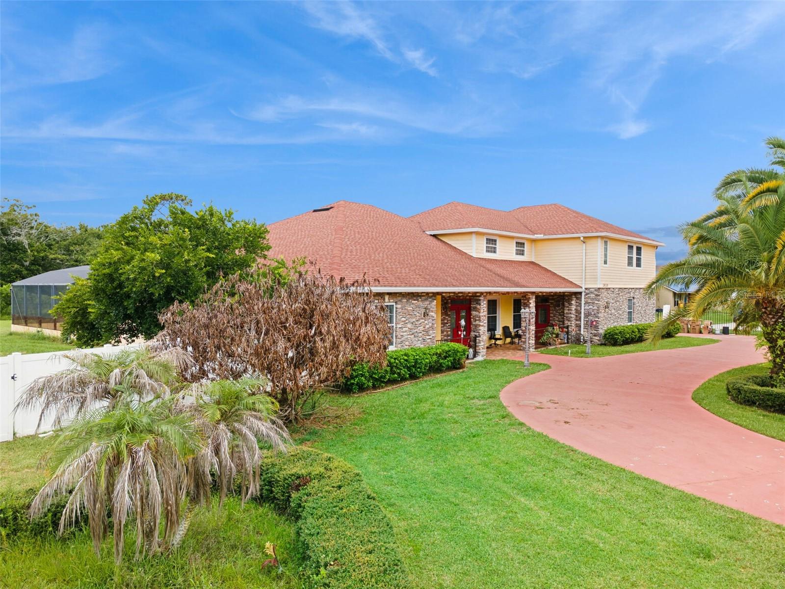 Welcome to this 5-bedroom, 4-bathroom pool home situated on a beautifully fenced 1-acre lot in Kissimmee. Offering space, privacy, and versatility, this unique property features an additional private living quarters above the garage, perfect for multi-generational living, guests, or rental income potential.

From the moment you arrive, you’ll appreciate the impressive circular driveway, side-facing garage, and expansive homesite surrounded by mature landscaping. Inside, the first floor offers a warm and inviting layout with vaulted ceilings, a spacious living room highlighted by a cozy fireplace, and a formal dining area ideal for gatherings.

The updated kitchen is thoughtfully designed with modern finishes, ample cabinetry, and generous counter space, making it perfect for everyday living and entertaining. The primary bedroom is conveniently located on the first floor, along with two additional guest bedrooms, offering comfort and privacy for family and visitors alike.

A standout feature of this home is the private second-floor living quarters above the garage, complete with its own entrance, full kitchen, living area, 2 bedrooms, and 2 bathrooms, providing endless possibilities for extended family, guests, or additional income opportunities.

Step outside and enjoy your own private retreat. Relax under the large covered patio or take a dip in the screen-enclosed in-ground pool while overlooking the spacious backyard and serene wooded area beyond, creating the perfect setting for peaceful outdoor living.

This one-of-a-kind property combines comfort, functionality, and privacy—all in a desirable Kissimmee location with convenient access to shopping, dining, attractions, and major roadways.