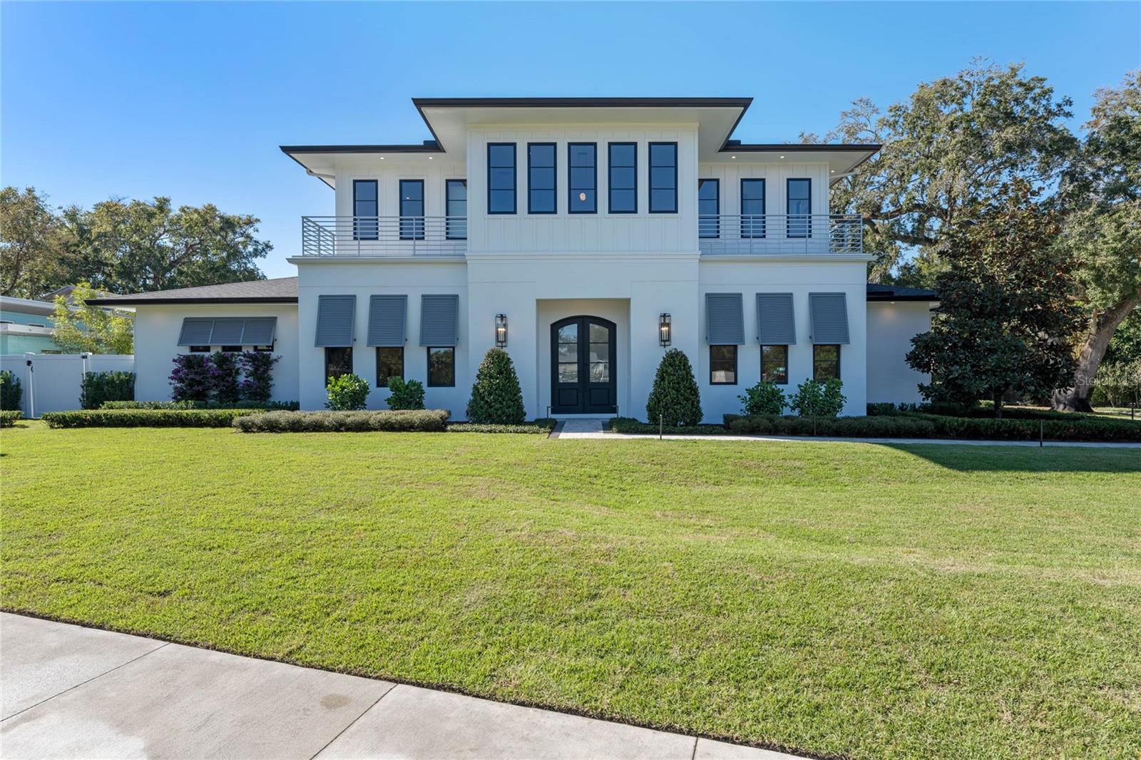 Welcome Home! This Modern Coastal new construction from FG Schaub Custom Homes is a 4,790-SF masterpiece complete with 5 bedrooms, an office, 5 full bathrooms, 3 half bathrooms, and so much more! No expense was spared on the quality and meticulous design of this stunning, new construction, two-story residence, boasting unwavering attention to detail and only the finest features and finishes throughout. A grand entrance beckons with a Handcrafted Iron front door that alternates from clear glass to frosted with the push of a remote button. A guest suite to the right of the entryway offers a comfortable and private retreat for guests that features an ensuite bathroom and walk-in closet. To the left of the entryway is a half bathroom and an office space allowing for privacy in a professional, home setting. Saunter into the spacious and open great room and soak in a beautiful view of the outdoor oasis and sparkling pool through the eight foot Anderson windows. This comfortable and welcoming room is the ideal place for relaxing with family and friends or for entertaining by the custom tiled, electric fireplace. For the home chef, the gourmet kitchen boasts a sleek Thermador appliance package with a microwave, coffee maker, range, custom hood, refrigerator, freezer and dishwasher. The walk in pantry offers extensive storage space, and the large center island has room for all to gather and flows beautifully into the great room.The exceptionally designed nearby primary retreat is the epitome of luxury featuring a large custom designed closet complete with a stackable washer and dryer, and a spa-like bathroom adorned with gorgeous accents. With separate vanities, a spacious shower with body spa and rain head, and freestanding soaking tub, this space offers the ultimate in stress relief. The upper level of this spectacular home contains three bedrooms, each with its own bathroom and large walk-in closet. All of the upstairs bedrooms are centered around a large activity room, which is ideal for spending movie night with family and friends, as a play area, game room or for cuddling up with your favorite book complete with a wet bar and dueling balconies. An additional powder room upstairs is conveniently next to the full-sized laundry room. Back downstairs, head outside through the accordion door in the great room to enter the transitional room with a ductless split, electric roll-away screens, pool bathroom and a full summer kitchen. The pool area is an entertainer's dream with a spacious Travertine paver deck, outdoor shower, and a firepit designed for late nights unwinding under the stars. An oversized 3-car garage with EV wiring provides ample vehicle space finished with epoxy floors and eye catching Get Lit LED lighting on the ceiling. Revel in the finishing touch of lush landscaping adorning this large corner lot property, making this an absolute dream destination with enviable curb appeal. Conveniently straddling the Orlando / Winter Park border, offering easy access to an array of boutiques, coffee shops, restaurants, events and farmers markets. Zoned for Audubon K-8 & Winter Park High!!