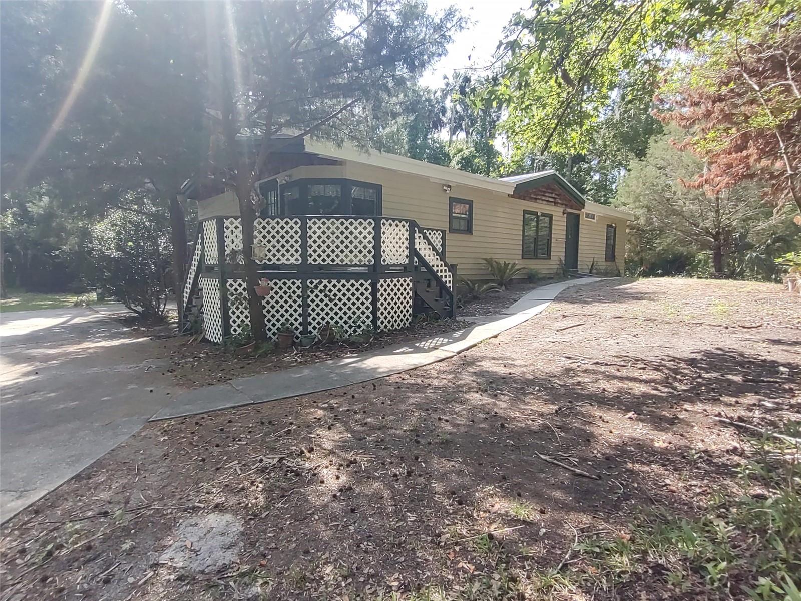 Rare Two-Home Compound on large, wooded lot - Private Boat Ramp Access & St. Johns River Views – Astor, FL

This property features two separate single-family homes on one beautifully wooded parcel (Lots 7 & 8, Block 73, Astor Forest Campsites unrecorded plat).  Surrounded by vacant lots on the sides, behind, and across the street, it delivers maximum privacy, open space, and a true peaceful country lifestyle with unobstructed waterfront views from both residences.

Directly across the street is the private AFPOA Blue Creek Park & Boat Ramp with covered picnic pavilion.  Enjoy the St. Johns River, Lake George, fishing, boating, and Ocala National Forest.  Membership to the boat ramp and park is optional.  NO HOA!

Updated 1991 Main Home (1,248 sq ft):  3 bedrooms, 2 bathrooms  
Remodeled bathroom and kitchen featuring brand new refrigerator and range  
Central A/C, cozy fireplace, and bright open living areas  
Attached open porch (112 sq ft)  
Durable metal roof

1968 Guest Cottage / In-Law Suite (846 sq ft):  2 bedrooms, 1 bathroom  
Ideal for extended family, guests, home office, or income-generating rental  
Metal roof

Total Living Area: ~2,094 sq ft across both homes

Additional Features:  Finished porch (253 sq ft) — perfect for relaxing with river breezes  
Large carport/pole shed (400 sq ft) — excellent for boats, RVs, vehicles, or workshop  
Ample room for gardening, animals, outdoor entertaining, or future expansion on this spacious.

No HOA or deed restrictions.  Unincorporated Lake County location offers flexibility and low-maintenance living.  Being sold as-is — move-in ready in the main home with updates already in place.

This one-of-a-kind setup is perfect for vacation home, 2nd home, multi-generational living, investors seeking rental income, or anyone wanting privacy, nature, and easy river access without the cost of direct waterfront.  

Don’t miss this rare opportunity in desirable Astor — schedule your private showing today!