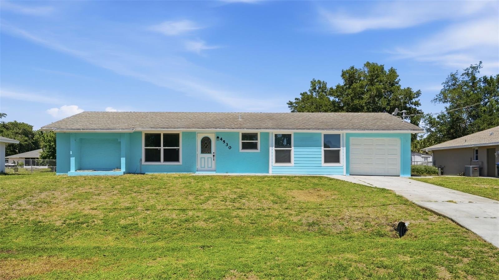Golden opportunity is rare, and this one is nestled right in the heart of North Port. Greenbelt stretching behind the huge and partially fenced-in backyard, non-flood zone, and on city water + sewer! This home is being sold AS-IS, and priced accordingly to be a wonderful investment of time and equity. Stepping into the living room, you'll see the huge backyard right out the French-door access to the patio, and even the kitchen sink area overlooks the greenbelt + the yard! The bedrooms are split, one on each side of the home, with the primary bedroom featuring it's own on-suite bathroom. This slice of Florida Sunshine could be your very own; take a look before it's gone!