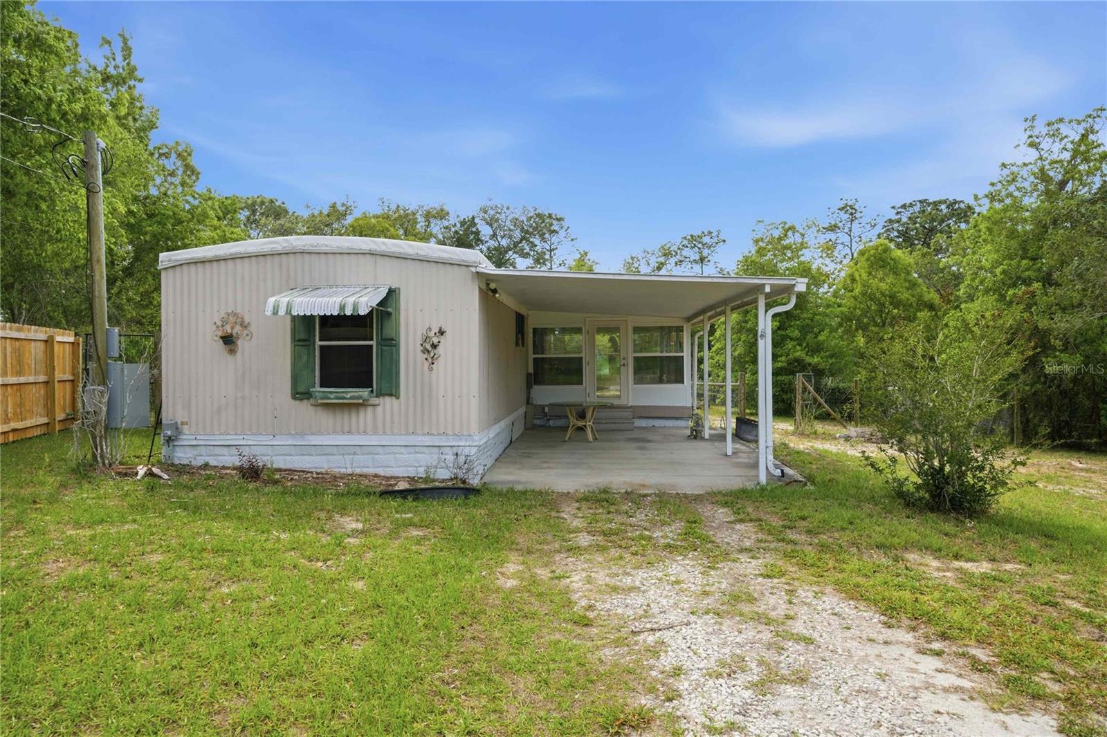 THE ULTIMATE HOMOSASSA MINI-COMPOUND ON .71 ACRES! Bring your trucks, tools, boats, and toys to this fully fenced, private oasis featuring NO HOA restrictions. Highlighting incredible street appeal, the property features a gorgeous premium wood privacy fence across the front with a gate, opening up to a massive, cleared .71-acre lot fully enclosed with durable chain-link fencing—perfect for pets, equipment, or secure storage. Storage and workspace capabilities are unmatched here: get a massive head start with a detached garage on a solid concrete slab, an impressive 14x20 powered workshop, and two additional storage sheds! The home itself represents the gold standard of energy efficiency and structural peace of mind. Rest easy under a brand-new 2025 60-mil TPO membrane roof—a premium, white-reflective system designed to maximize leak protection and drastically slash your cooling bills. Relax in the stunning, newly added Florida room, completely outfitted with high-efficiency, hurricane-resistant argon gas double-pane windows. Inside, this pristine 2-bed, 1.5-bath home shines with modern upgrades including luxury vinyl plank flooring throughout, brand-new contemporary fixtures, and a gorgeous kitchen boasting custom butcher block countertops. Major mechanicals are entirely turn-key with an updated 2021 electrical panel and a 2019 AC (fully serviced in 2025). Exceptional land utility, pristine infrastructure, and total security—schedule your tour today!