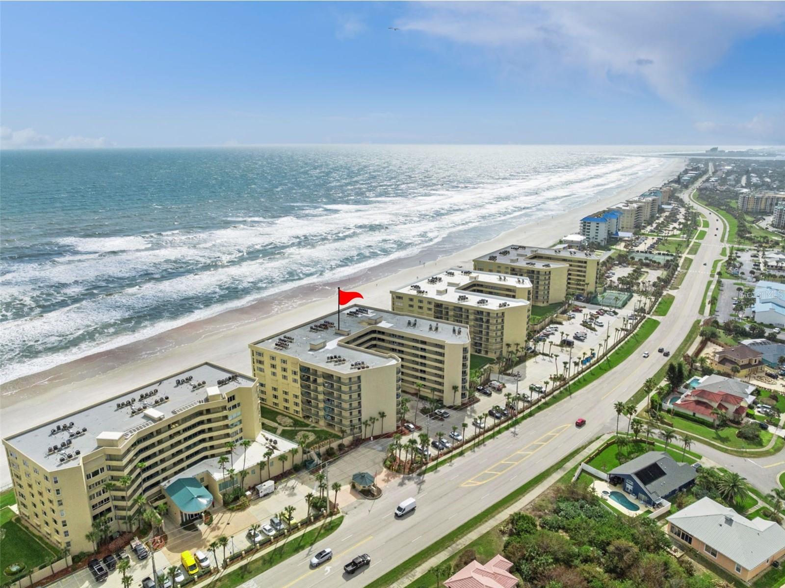 Experience Coastal Luxury at its finest in this completely reimagined OCEANFRONT CONDO in desirable Ponce Inlet. This stunning 3 Bedroom, 3 Bathroom residence has been Fully Remodeled from top to bottom, where every square inch has been thoughtfully upgraded to deliver modern elegance and effortless comfort.  Offered Fully Furnished!  2,400 Square Feet of Living Space under Heat and Air. Enhancement creates a versatile, climate controlled area perfect for a sitting room, office, or extended living space while seamlessly blending with the rest of the home. Discover a bright, open layout featuring fresh interior paint with stylish new lighting and paddle fans throughout.  The beautifully redesigned kitchen offers New Cabinetry, Premium Appliances, and a charming eat in dining space, perfect for both everyday living and entertaining.  A spacious family room provides a welcoming place to relax while also being able to view the waves crashing into the soft sandy beach. Every Bedroom has a Private Ensuite and they have all been tastefully renovated with high end finishes.  Plenty of Space to Create a Private Office that is away from the main home and separate from the bedrooms.  The Ocean Front Home is equipped with a newer HVAC system (November 2024), new copper piping throughout and hurricane impact windows for peace of mind.  Plantation shutters add a timeless coastal touch throughout.  A laundry room with new washer and dryer adds modern convenience.  Wake up to breathtaking sunrises and unwind to the sound of the waves from not one, but THREE DIRECT OCEANFRONT BALCONIES offering unparalleled views of the Atlantic.  This exceptional community offers resort style amenities including a full-size gym, sauna, clubhouse with kitchen, billiards room, mini library, recreation room, sparkling community pool, and secured underground parking.  Perfectly located near the iconic North Turn on a no-drive beach, you’ll enjoy private coastal setting while remaining just minutes from the dining, shopping, and entertainment of Port Orange and Daytona Beach.  This is more than a condo, it’s a FULLY UPGRADED BEACHFRONT RETREAT ready for you to enjoy year-round.