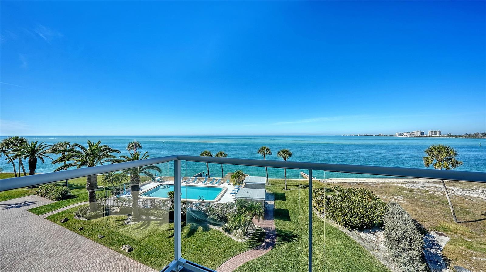 Experience refined coastal living in North Siesta Key at 4708 Ocean Boulevard, a fully renovated 2025 corner residence ideally positioned on the Gulf of Mexico at Big Pass. This exceptional 3-bedroom, 3-bath condominium offers unobstructed panoramic views of the Gulf, Sarasota Bay, and distant vistas of Lido Key and downtown Sarasota. Encompassing 2,277 square feet with miles of Gulf-front views, the residence has been thoughtfully redesigned with wide-plank European engineered oak flooring, impact-rated windows and doors, and integrated smart-home technology throughout. The chef’s kitchen is a statement in both form and function, featuring custom cabinetry, Milano Dolomite countertops, a striking Macaubas Quartzite island, and premium GE Café appliances—perfect for entertaining against a backdrop of endless blue water. The primary suite is a private retreat with direct access to a Gulf-front balcony and a spa-inspired bath complete with dual vanities, rainfall shower, and bidet. Two additional guest suites provide comfort and privacy, each finished with designer details. 
Additional highlights include a two-car tandem garage with hurricane-rated door, new HVAC systems, electric hurricane shutters, and an integrated sound and entertainment system. Amenities include a heated pool, guest parking, and direct walking access to the sugar-white sands and vibrant Village of Siesta Key. This residence blends timeless coastal elegance with modern luxury—an extraordinary Gulf-front retreat on one of Siesta Key’s most coveted stretches of shoreline.