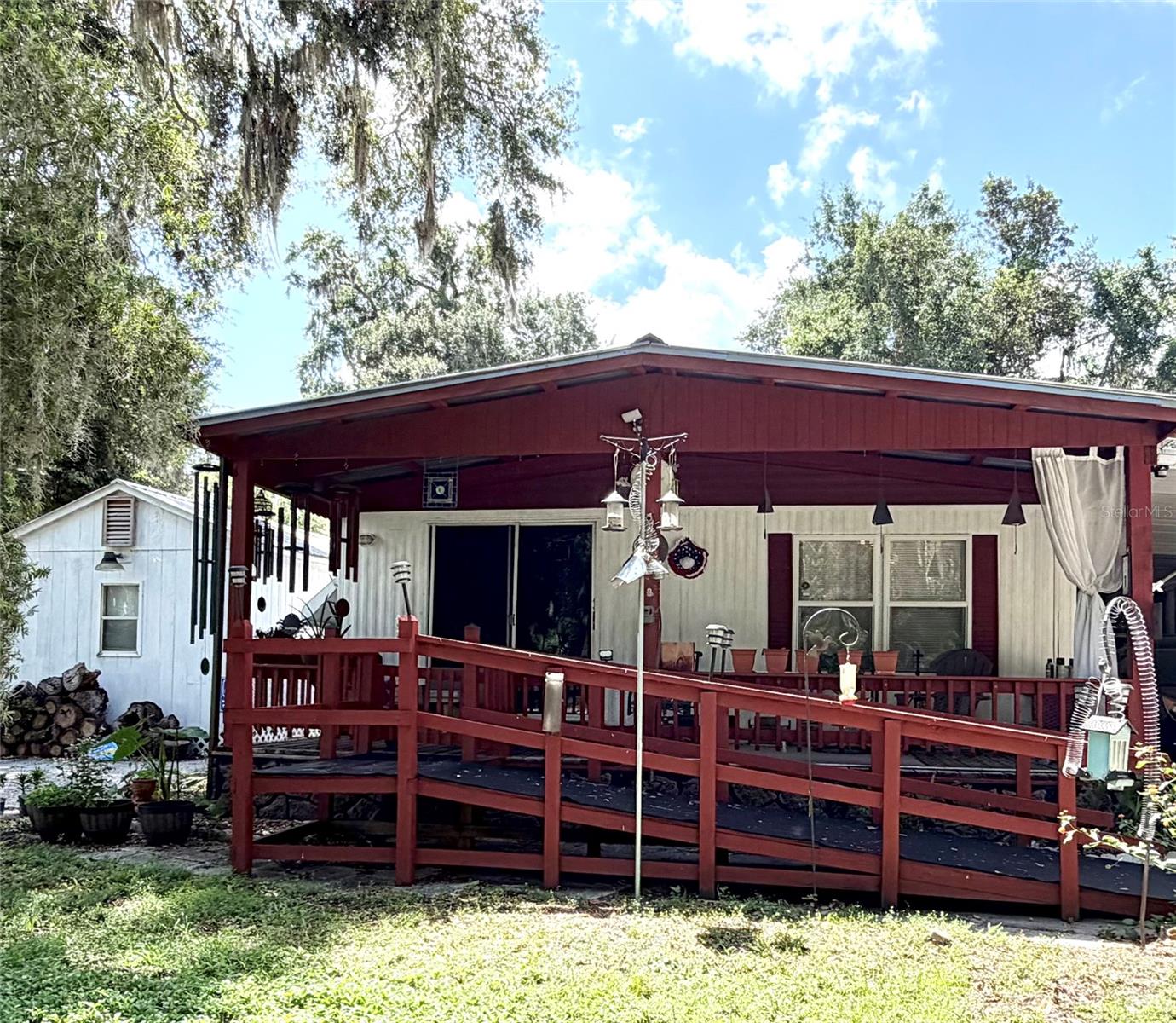 Welcome to  a charming peaceful retreat nestled in the heart of Old Florida living. Situated on an oversized corn lot this  2-bedroom, 1.5-bath home offers privacy, outdoor space, and the relaxed lifestyle that makes this area so desirable. The property features a spacious covered front deck, screened porch, carport, multiple storage buildings including a large workshop,  and a fenced yard perfect for entertaining, gardening, or simply enjoying the quiet surroundings.

Both the front and rear patios feature convenient ramp access, offering added accessibility and ease of entry throughout the home.
The property comes with a 24x12 workshop with insulation added to keep it cool. A 10x6 shed for lawn equipment and even a shed that could be used as a greenhouse. The property is fully fenced. 

Located just minutes from the sparkling waters of and the scenic, this property is ideal for fishing enthusiasts, nature lovers, and anyone seeking a slower pace of life. Known for world-class bass fishing, boating, and wildlife viewing, Lake Panasoffkee offers a true small-town Florida atmosphere while remaining conveniently close to I-75 for easy access to Ocala,  Tampa and The Villages. Located nearby Marsh Bend Outlet park with a fishing pier, boat ramps and access to a hiking trail. Nearby local restaurants, public boat ramps, and outdoor recreation make this a perfect full-time residence, winter getaway, or investment opportunity. Furnishings are negotiable making this an easy move to experience the Old Florida lifestyle.