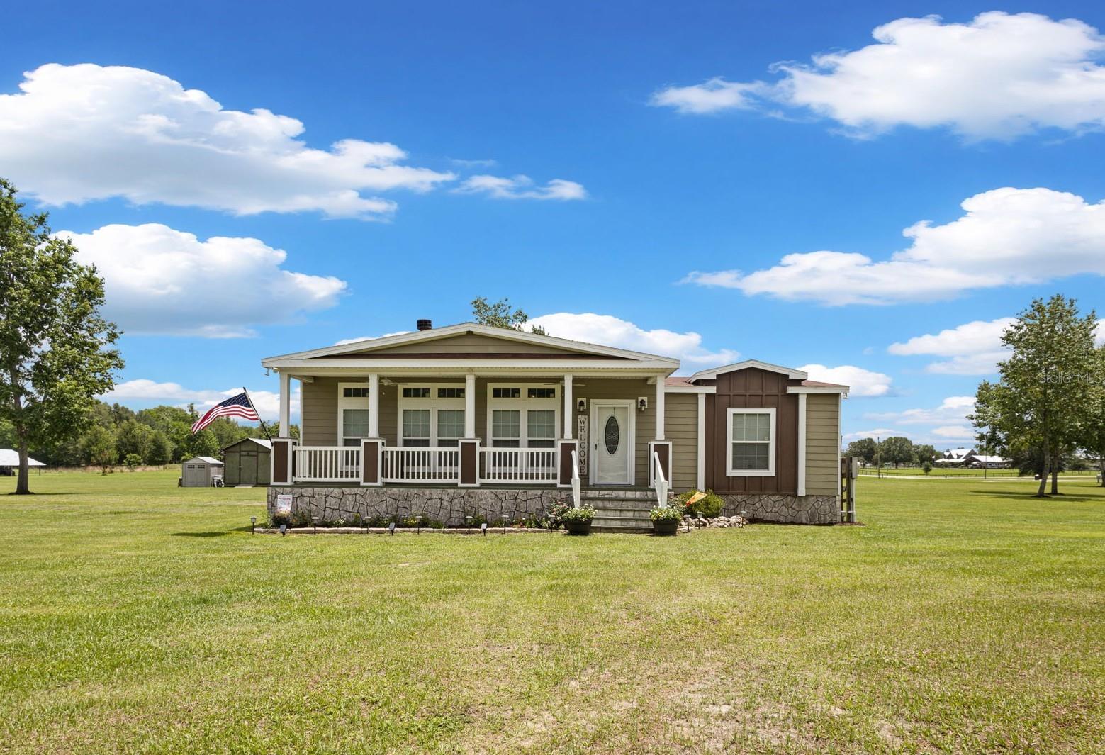 FORT WHITE FL HOME FOR SALE ON 5 ACRES! This beautifully maintained 4-bedroom, 2,500 sq ft North Florida country home offers paved road frontage, mature trees, modern upgrades, and plenty of room for horses, a pool, or outdoor living — all just 5 miles from town. From the moment you pull in, this property just feels like home. Inside, you’ll love the open floor plan, cozy fireplace, and stunning kitchen featuring a large center island, farmhouse sink, custom wood cabinetry, built-in oven and walk-in pantry — perfect for entertaining or gathering with family. Crown molding throughout adds an extra touch of craftsmanship, while barn doors open to reveal a bonus room ideal for a playroom, media room or just extra space! The spacious primary suite was designed for relaxing, with twin vanities, an oversized spa-style shower, and a soaking tub perfect for unwinding after a long day. Step outside and enjoy peaceful afternoons on the front porch or evenings around the fire pit under the North Florida skies. There’s also an outside storage building and plenty of room to create the backyard oasis you’ve been dreaming about. A 30-amp RV hookup is ready for extra guests or a generator. IF YOU’VE BEEN SEARCHING FOR A MOVE-IN READY HOME ON 5 ACRES WITH COUNTRY CHARM, THIS ONE IS DEFINITELY WORTH A LOOK!