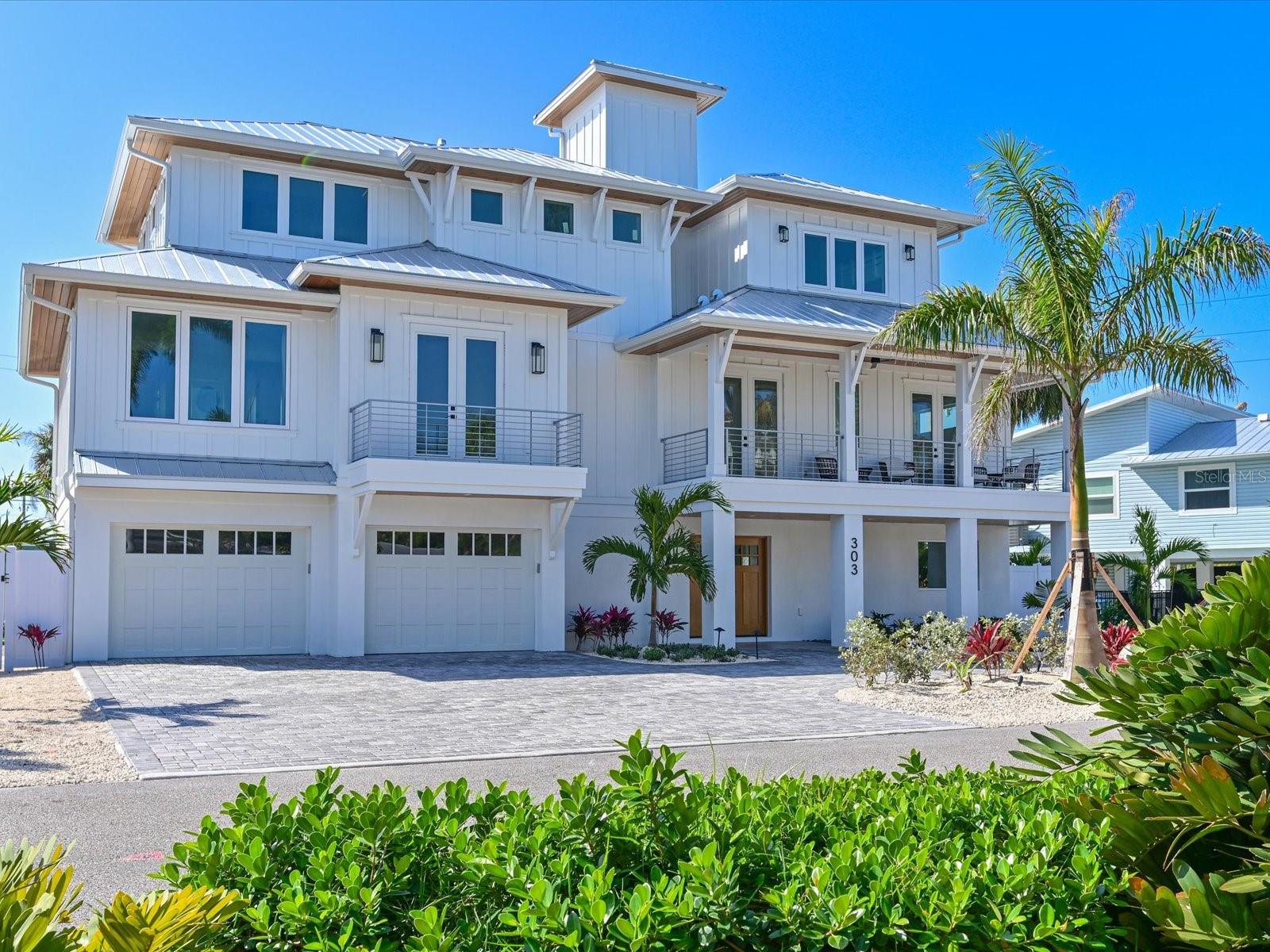 Brand new construction completed in 2026, luxury home in the heart of Holmes Beach on beautiful Anna Maria Island, just two blocks from the white-sand Gulf beaches. This fully professionally furnished 4-bedroom, 4.5-bath coastal retreat offers the perfect blend of modern design and island living. The open-concept floor plan features a spacious living area with high ceilings and abundant natural light, flowing seamlessly into a chef’s kitchen equipped with premium Thermador appliances, custom cabinetry, a large center island, and a convenient under-counter ice maker—perfect for entertaining family and guests. Each bedroom includes its own en-suite bath, providing privacy and comfort, while the additional half bath is ideal for visitors. Equipped with an elevator going from the ground floor to the beautiful rooftop deck. Professionally designed and sold turnkey furnished, this home is ready for immediate enjoyment or use as a luxury vacation rental. Owner will be listing it as a brand new short-term rental as well. Step outside to your private resort-style backyard oasis featuring a heated pool and spa, covered lounge area, and a custom putting green surrounded by tropical landscaping and turf along with a beautiful custom deck. Multiple outdoor entertaining spaces create the perfect setting for relaxing after a day at the beach. Located only a short stroll—approximately two blocks—from the Gulf of Mexico, this exceptional property offers easy access to pristine beaches, dining, and shopping while maintaining the privacy of a quiet island neighborhood. Whether you’re seeking a full-time residence, second home, or high-end investment property, this brand new Holmes Beach home delivers luxury, location, and the ultimate Anna Maria Island lifestyle.