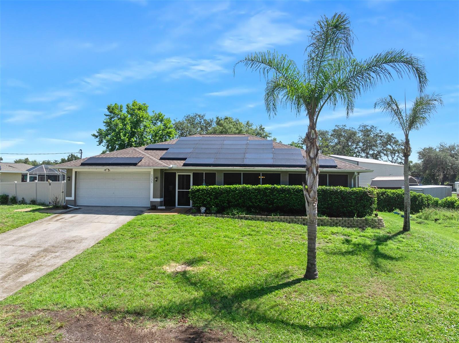 Welcome home to your peaceful slice of Florida Living!! Located in a perfect spot that is convenient to all things DeLand and Daytona Beach, this home features 3 bedrooms, 2 baths and almost 1,900 sq ft of living space. Some recent updates include: new windows in 2021, new roof 2018, HVAC 2021, solar panels 2021, and water heater 2021. Situated high on almost a half acre of land, this property has low utility bills! You're not quite off the grid, but monthly expenses are so much more affordable with NO HOA, well, septic, and solar panels (to be paid off by seller at closing) for considerably less power bills. This home offers a split bedroom floor plan with a formal living room, dining room and separate family room with dinette. Enjoy the summer in your enclosed lanai overlooking the fully fenced back yard with wood entertainment deck and beautiful above ground pool!