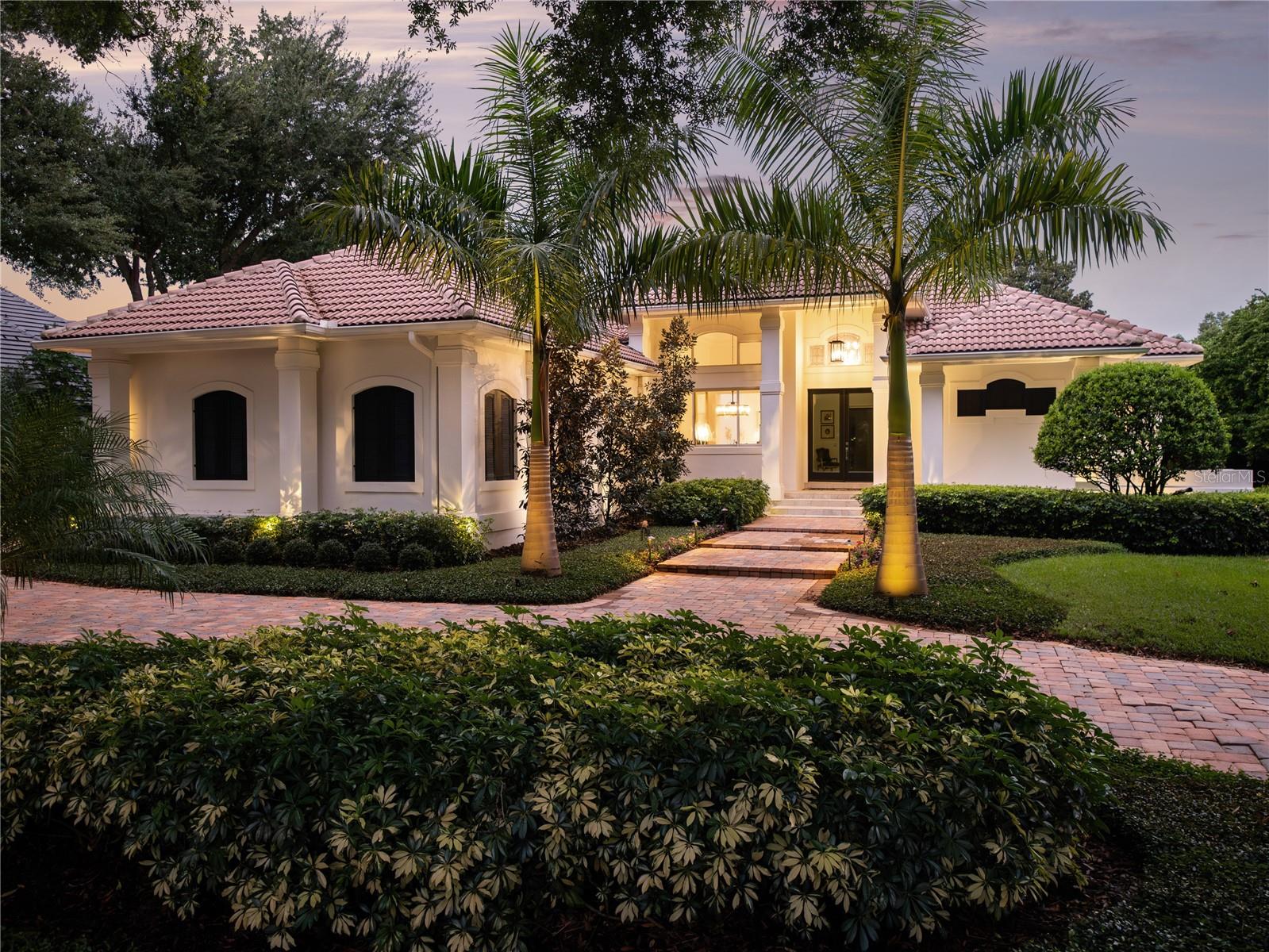 Welcome home to this beautifully renovated, villa-style retreat located in renowned guard gated Isleworth Golf & Country Club. This home exudes the ideal balance of unwavering luxury and comfort and features only the finest upgraded features and finishes. This meticulously designed home is ideally located along the 4th fairway of the famed Isleworth Golf Course. The expensive entry opens up to the living and dining rooms and from there, a large kitchen with spacious island, comfortable breakfast nook, Butler’s pantry with Insta-shot water system, custom-built bistro shelves and more. The spacious family room and bar boasts a floor-to-ceiling tile wall, Cambria countertops, Milk glass bistro-style light fixtures, Ruvatti deep sink -Kohler gentleman’s bar faucet and R/O water filtration system. Full ensuite bathrooms are on each bedroom, and the spacious downstairs primary suite offers the perfect amount of privacy while remaining close to the home’s center. Other highlights include a catering buffet, separate laundry, upstairs bonus room with balcony, and pool half bath with gorgeous black marble vanity, crown molding and Kohler toilet and faucet. New lush landscape lighting covers the entire property and feels like a tropical oasis. The impressive outdoor living area with covered patio has additional updated landscaping, a putting green and Travertine tile. A sparkling oversized pool with heater and spa is perfect for entertaining family and friends or for enjoying a peaceful evening under the stars. The oversized three-car garage sits by the circular drive with brick pavers, and the newly added mudroom is an excellent convenience for busy families coming and going. Recognized as one of the Top 100 Platinum Clubs of the World, the 600-acre golf club community of Isleworth Country Club is also surrounded by the famed, Butler Chain of Lakes. The optional membership includes exceptional amenities of a championship golf course, tennis courses, dining, and social activities and opportunities. Schedule your private tour of this exceptional property today and experience the true luxury of this must-see Isleworth home.