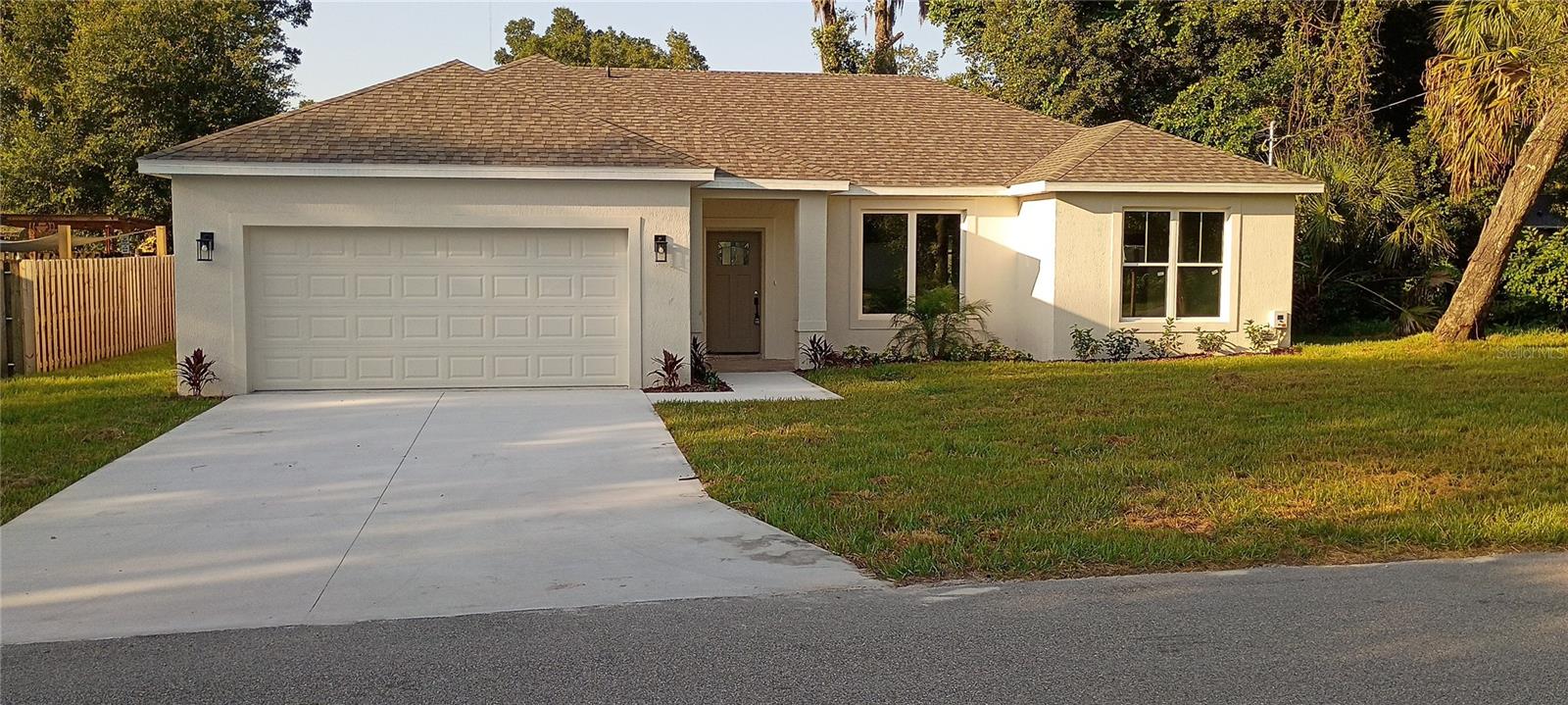 NEW BUILD!! NOW is YOUR time!! This beautiful new home is located in a quiet neighborhood with no HOA fees! Perfectly nestled on a quiet street, you'll be wanting to call this 1,530 square foot, 3/2 split floor plan "Home Sweet Home!" The main living area is open to the kitchen and boasts soaring ceilings that provide a spacious, open feel. The gorgeous kitchen includes stainless-steel appliances, 42" cabinets and a granite-topped island. The Owner's Suite features a large walk-in closet and the private bathroom includes a step-in shower with custom tile and a large corner soaking tub. Additional features include ceiling fans in all bedrooms and living area. Don't miss this incredible opportunity!