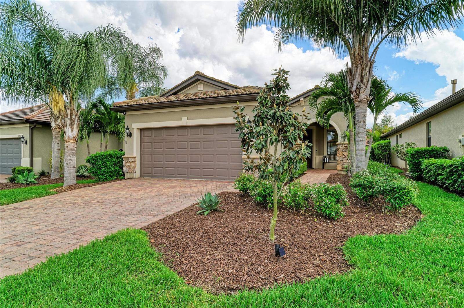 Must see this beautiful single family home, the Steel Creek Model! 2 bedroom, 2 bath home in Del Webb of Lakewood Ranch, Resort-Style Living at Its Best! Experience the Florida lifestyle in the highly sought-after Del Webb, a 55+ maintenance-free, gated community with amenities galore. This beautiful home offers an incredible opportunity to enjoy resort-style living with all the comforts and conveniences you desire. This stunning home features two spacious bedrooms and two modern bathrooms, providing ample space and privacy for residents and guests alike. Enjoy the tranquil Florida evenings on your private screened lanai with a picturesque view of the pond. The peaceful setting extends to a private backyard, perfect for relaxation, and an inviting front porch where you can unwind and savor the moment. The open-floor plan enhances the spacious feel of the home and is ideal for entertaining. The gourmet kitchen is a chef's dream, featuring a large center island, beautiful countertops, and sleek stainless steel appliances. It is the perfect setting for hosting friends and family. The entire interior has been freshly painted, and the bedrooms now boast new carpeting for added comfort and style. New light fixtures in the living area and kitchen make the home light and bright with a touch of style. The garage floor has been treated with durable epoxy, and modern conveniences such as a Ring doorbell and Nest remote-controlled thermostat have been installed for added security and energy efficiency. The primary bath has been upgraded with a new frosted shower door, complementing the double sinks, walk-in shower, and large closet in the expansive Primary Bedroom Suite. Living in Del Webb of Lakewood Ranch means access to an array of world-class amenities: Enjoy an active lifestyle with 6 tennis courts, 8 pickleball courts, and 4 bocce ball courts. Relax at 2 swimming pools or maintain your fitness routine at the state-of-the-art fitness center and group fitness studio. The community clubhouse includes a catering kitchen and a game/card room. Dine at the Lake House restaurant, which offers a full-service bar and restaurant with breathtaking lake views. A full-time lifestyle director curates a variety of events and activities, ensuring there’s always something exciting happening. Del Webb of Lakewood Ranch is centrally located, providing easy access to the restaurants and shopping of the UTC mall area, Several golf courses and medical facilities and our pristine Gulf beaches are just a short drive away. This home is truly a must-see for anyone looking to embrace an active lifestyle in a vibrant community. What more could anyone ask for? Make this dream home yours today!