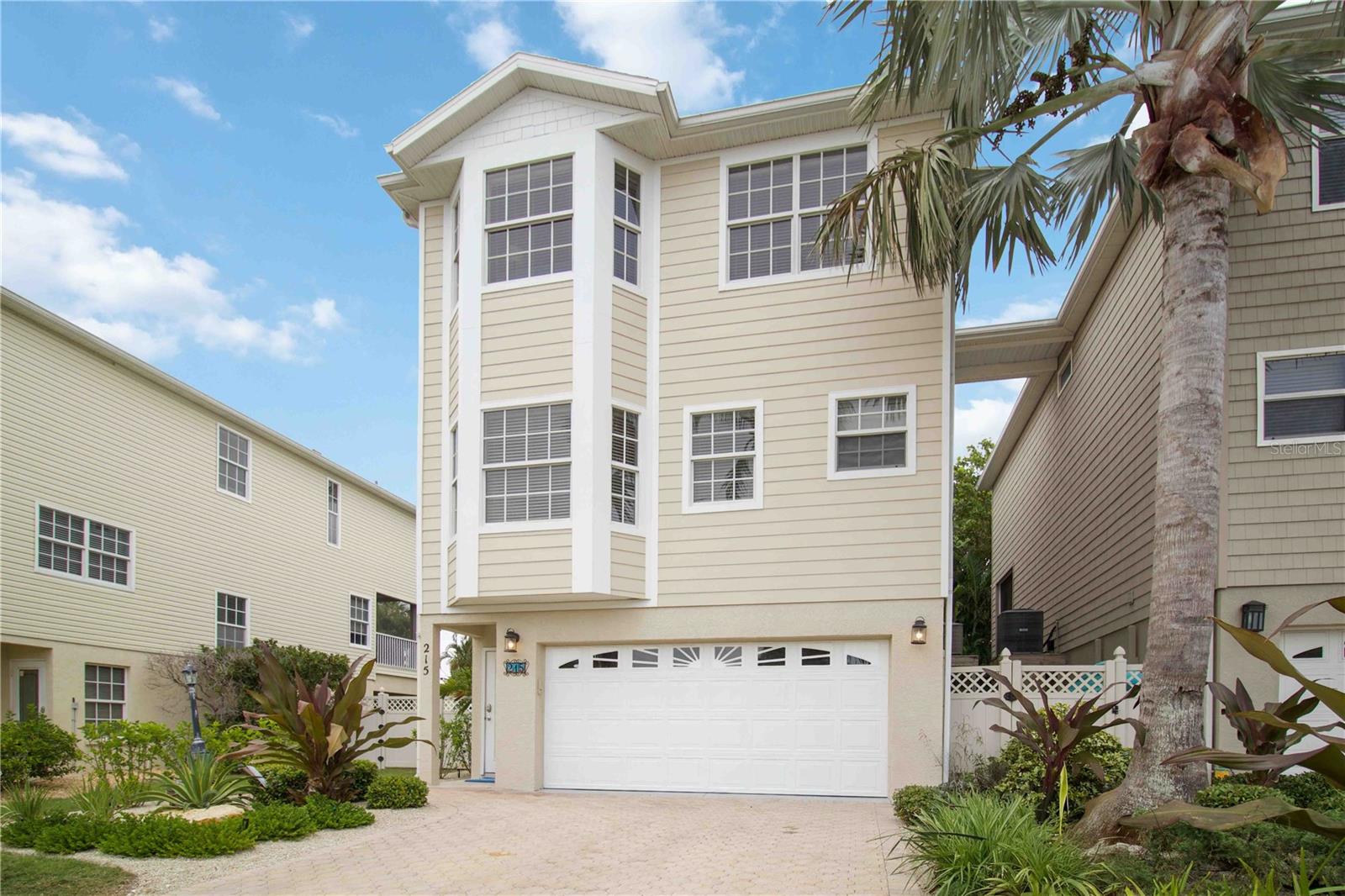 Newly updated with fresh paint throughout, brand new stainless steel appliances, quartz countertops on kitchen and bathrooms and so much more!! Nestled near the north end of Anna Maria Island, 215 81st Street is a three-bedroom, two and a half bath home boasting over 2,000 square feet of living space—an Airbnb gem zoned for weekly rentals. Just two blocks from some of the island’s most pristine beaches, this property offers a true tropical paradise out back. The fully fenced oasis features a gorgeous pool with a built-in hot tub, while the expansive paver-lined lounge area creates a true island escape.

 The elevated design includes a two-car garage and a game room—currently set up with a ping pong table, connect 4, and Tic Tac Toe but offering ample space to add additional attractions for guests.  The second floor invites you into a bright, open living, dining, and kitchen area featuring a brand new LG stainless steel appliance package and gorgeous quartz countertops. This floor also features a half bath, complemented by a massive, screened-in balcony deck (freshly screened in less then a year ago) overlooking the pool oasis below—perfect for soaking in the tropical ambiance. You will also find a dedicated interior laundry room with full size washer and dryer on this floor as well. On the third floor, you’ll find three spacious bedrooms and two full baths, with the primary suite offering not only luxury but also absolutely gorgeous views from every angle—a panoramic reminder of the beauty that surrounds you on Anna Maria Island.

This home is packed with recent updates: a 2022 roof, 2019 AC, and a brand-new water heater. The exterior shines with hardie board siding installed less than a year ago and fresh paint. Beyond the home, you’re a stone’s throw from Pine Avenue’s charm and all that Anna Maria offers—laid-back vibes, local eateries, and coastal culture. Fully furnished and turnkey, this is both a thriving investment and an island escape waiting for you.