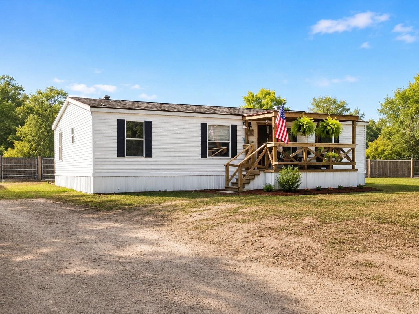 Completely renovated in 2022, this charming 3-bedroom, 2-bath home offers modern updates with the comfort of a quiet, private setting. Situated on a spacious half-acre, the property features a fully fenced backyard with mature plants and trees, cozy front porch and large back deck off the kitchen, perfect for relaxing, gardening, or entertaining. Enjoy the convenience of being just 1 mile from downtown High Springs, known as the “Gateway to the Springs.” Walk or bike to local shops, restaurants, and all the charm this vibrant small town has to offer.
The bathrooms, tile, kitchen, appliances, including the washer and dryer, all new flooring, front porch, and rear deck were all renovated in 2022, the roof and A/C were also replaced in 2022.