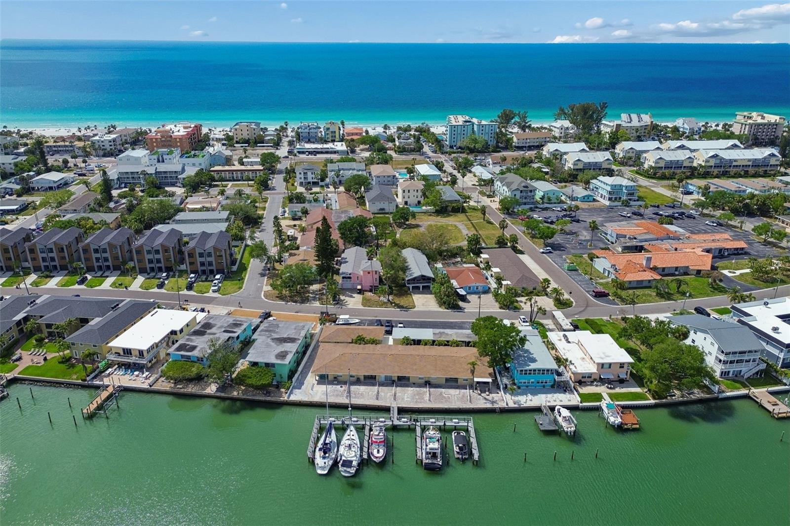 Exceptional opportunity to own an expansive waterfront lot in highly sought-after Indian Rocks Beach. Situated on three contiguous lots, this unique property allows for multifamily with short term rental zoning. Currently it features eight well-appointed units and six deepwater boat slips, creating multiple income streams and offering both immediate revenue potential and long-term upside. Recently renovated in 2026, the property offers a well-balanced unit mix with five 2-bedroom, 1.5-bath units and three 1-bedroom, 1-bath units, appealing to a wide range of renters. Six units—including four 2- bedroom and one 1-bedroom—enjoy beautiful water views with sliding glass doors opening to covered porches and shared outdoor spaces overlooking the bay, while two additional 1-bedroom units are located in a detached front duplex. The property is comprised of three separate buildings arranged around a charming palm-lined courtyard. The waterfront building includes the majority of the units with direct water views and access, while a third structure provides six covered carports, eight private storage rooms, a common laundry facility, and an EV charging station. Boating enthusiasts will appreciate the on-site marina with six deepwater slips accommodating vessels up to 50 feet, complete with electric (110V/220V), water hookups, and individual dock boxes, with projected boat slip income of approximately $45,000 annually. With approximately 160 feet of water frontage, this property delivers true coastal living. Previously operated as an annual rental, the property presents significant upside through conversion to short-term rentals, as Indian Rocks Beach allows for short-term leasing—making it an ideal opportunity for investors looking to maximize returns or reposition as a boutique hotel or motel concept. Additional highlights include ample guest parking and walkability to the beach, enhancing both tenant and guest appeal. STR AirDNA reports available upon request. With recent renovations complete, multiple revenue streams, and a prime waterfront location, this is a rare chance to acquire a high-performing, high-upside asset in one of Florida’s most desirable coastal markets. Seller financing available—contact for details.
