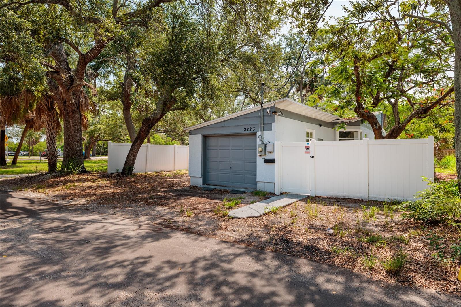 Welcome to 2223 W Harbor Dr S, situated within a short distance to several historic areas of St Petersburg, this home is clustered in conservation under the canopy of nearby trees. Great location, only a few minutes south of the USFSP Campus, the local hospitals and Downtown St Pete. Public walking and biking paths are available for the whole community to enjoy. Public transit is also accessible and so convenient for getting around the city, or county. Less than 10 minutes drive to Gulfport and easy access to St Pete Beach/Treasure Island via South Pasadena. Private backyard, this lot is on conservation land along the north and east property line. The home has been completely restored after the 2024 storm season. 1 car garage with additional fenced in parking pad. Electrical, plumbing, drywall, interior finishes have been updated and a whole new kitchen was installed. The kitchen has extra deep quiet close cabinets and drawers with ample storage for all your cooking essentials. The island features cabinets on both sides and doubles as a breakfast bar. A pantry is adjacent to the kitchen making the work area beautiful and efficient for the modern chef. In addition, the layout features 2 bedrooms, 1 bath, oversized living room with vaulted ceilings, and a den/3rd bedroom. Mid Century Modern architecture with “quarter century 2k” modernizations. A beautiful home in a community driven city. This home has great location, constant stability and incredible value worth seizing. Schedule your showing today!