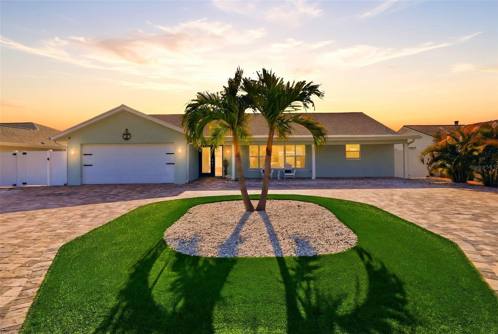 Deep water waterfront pool home with 13,000 lb boat lift just three blocks from the Gulf beaches in highly sought after St. Pete Beach, offering the ultimate combination of boating access, walkable beach lifestyle, and luxury coastal living. This exceptional 4 bedroom, 2 bath single story residence has been fully updated with modern finishes and high end upgrades, delivering a seamless blend of style, comfort, and functionality in one of Florida’s most desirable waterfront communities. Inside, porcelain tile flooring flows throughout the open concept layout, creating a clean, durable, and sophisticated living space designed for both everyday living and entertaining. The chef’s kitchen is a true standout, featuring upgraded Bespoke appliances, a sleek matte cooktop, wine refrigerator, and striking quartz countertops that elevate both form and function. The spacious living area is anchored by a contemporary electric fireplace, adding warmth and a refined focal point.
Thoughtful enhancements include hurricane screens for added protection, a smart Ecobee thermostat for energy efficiency and climate control, plantation shutters, and sliding glass doors with built in blinds that create effortless indoor outdoor flow, privacy, and convenience. Step outside to your private tropical waterfront retreat where a resort style pool with sun shelf invites you to relax in the Florida sunshine. The custom pergola is fully equipped with electrical and dual mounted televisions, creating an elevated outdoor living and entertaining space designed for year round enjoyment. Low maintenance AstroTurf in both the front and backyard ensures lush, green curb appeal without the upkeep. Boating enthusiasts will appreciate the composite dock and deep water access with a 13,000 pound boat lift, along with an additional slip capable of accommodating a vessel up to 50 feet, offering direct access to the Intracoastal Waterway and the Gulf for boating, fishing, and sunset cruising. The pavered circular driveway enhances curb appeal while providing ample parking for guests. Located in the heart of St. Pete Beach, this property offers close proximity to pristine beaches, waterfront dining, and coastal recreation, while being just a short drive to downtown St. Petersburg, known for its award winning restaurants, boutique shopping, art galleries, waterfront parks, and vibrant cultural scene. This is a rare opportunity to own a fully upgraded waterfront home that delivers luxury, location, and the best of Florida coastal living.