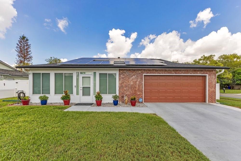 Discover refined living in this exquisitely appointed 3-bedroom, 2-bathroom residence, offering 1,538 square feet of elevated comfort in the heart of Kissimmee. Every major system has been meticulously upgraded, presenting a rare opportunity to acquire a home where the significant investments have already been made — leaving nothing to do but move in and indulge. The property is powered by a fully owned home solar system with battery backup, delivering exceptional energy efficiency and lasting value. The roof was replaced in 2019. The attic was previously finished with a silver reflective coating engineered to minimize heat absorption and enhance cooling efficiency. The home was completely replumbed in 2024, including a new commercial grade water heater. A whole-home surge protection system safeguards every appliance, while a new stove top, added in 2023, complements the residence's polished interior. Freshly painted throughout, the home presents a crisp, gallery-like ambiance from room to room.Step outside to a private outdoor sanctuary designed for effortless entertaining and serene relaxation. The screened, enclosed pool — easily converted back to pristine saltwater — is powered by a new variable-speed pump installed in 2023, ensuring whisper-quiet, energy-conscious operation. Custom-fitted screens enclose the space, while remote-controlled solar shades offer instant, on-demand shade. Remote landscape lighting transforms the grounds into an ambient retreat after sunset. An outdoor rain shower delivers a resort-inspired finishing touch. For alfresco dining, the fully appointed outdoor kitchen boasts a marine grade grill, pizza oven, beverage center, and refrigerator — an entertainer's dream built for Florida's golden evenings. Inside, the primary suite features a lavishly remodeled bathroom (2025), while the secondary bath has been tastefully updated with a sleek, contemporary shower. The kitchen is the picture of elegance, anchored by a striking handcrafted copper sink that serves as both function and art. A sun-drenched, air-conditioned sunroom invites natural light to pour through the home, creating an airy, inviting space for quiet mornings or lively gatherings. With its impeccable upgrades, resort-caliber outdoor living, and designer interior touches, this residence stands as a rare offering — polished, efficient, and entirely move-in ready. Schedule a private showing today to experience this exceptional home firsthand.