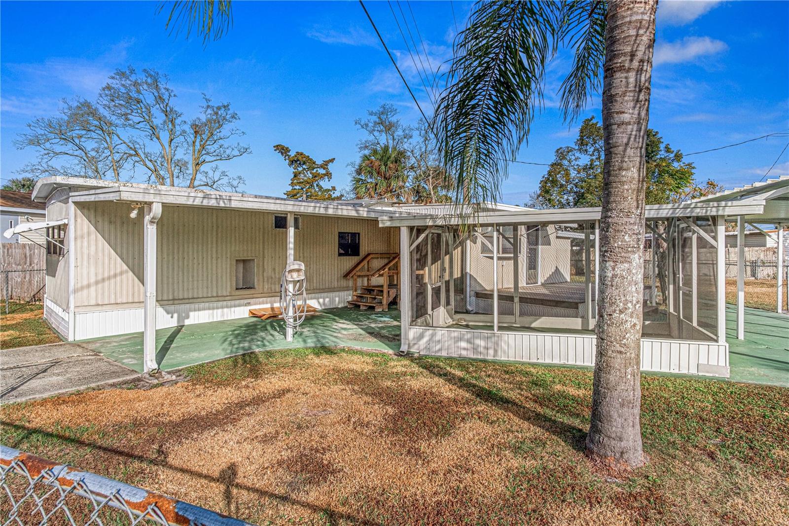 No HOA! You Own the Land! Private Financing Available! This well-maintained and versatile mobile home offers an affordable opportunity to enjoy Florida living with the freedom of owning your own property. The bright, inviting interior features a spacious bump-out living room, 2 bedrooms, 1 full bath, and a dedicated office space conveniently located just off the kitchen—perfect for working from home, hobbies, or extra storage. Outdoor enthusiasts will appreciate the property's exceptional functionality, including two covered carports, a screened porch nestled between them for relaxing or entertaining, and ample space for RV, boat, or trailer parking. The detached utility shed is equipped with electricity, making it ideal for a workshop, craft room, or storage, while the utility room includes laundry hookups for added convenience. A rare combination of flexibility, workspace, and parking options, this move-in ready property is perfect for full-time residents, seasonal owners, or anyone seeking affordable Florida living with room for all their toys. All information taken from the tax record, and while deemed reliable, cannot be guaranteed.