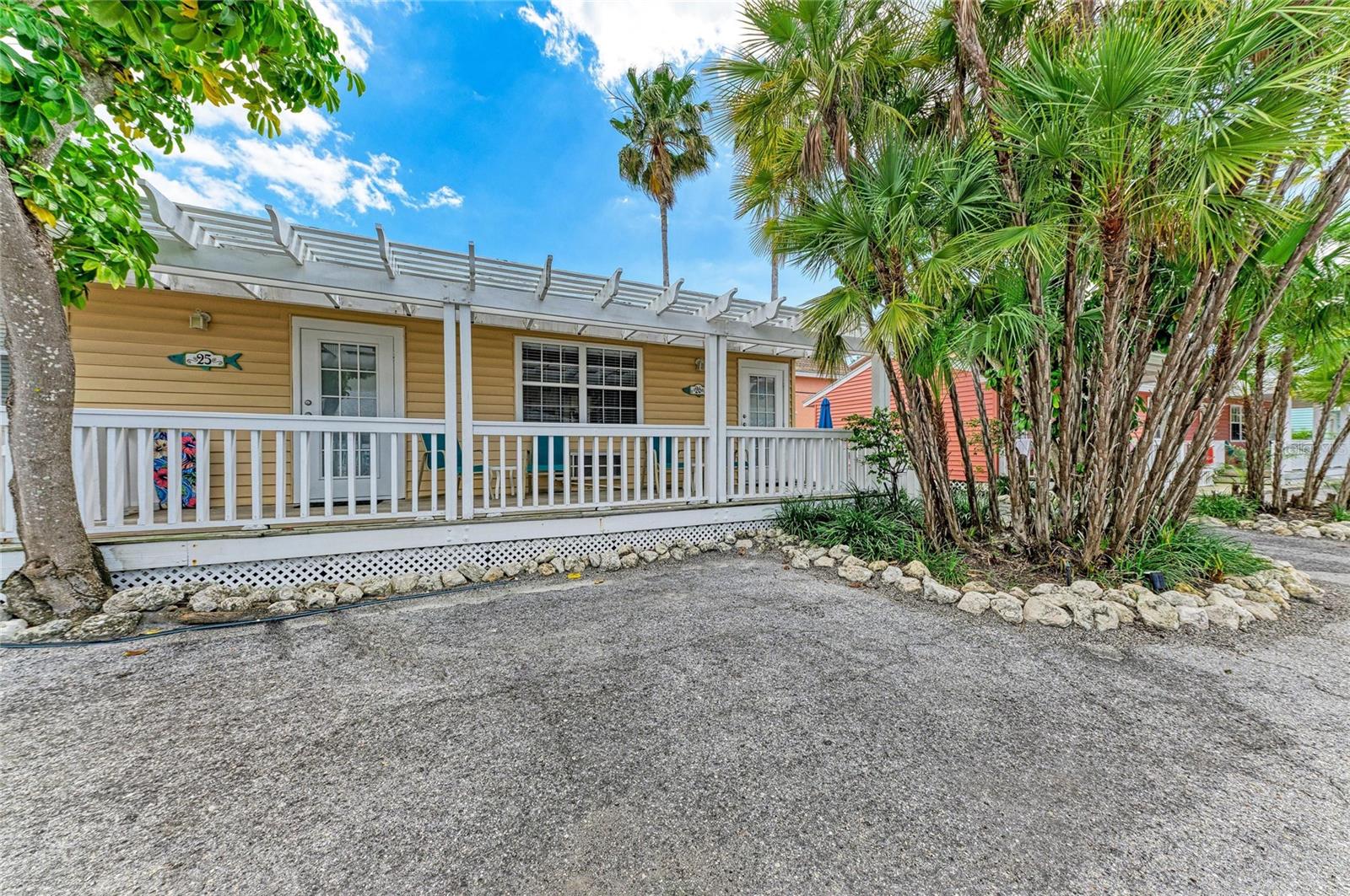 Enjoy Island Cottage life for under $350,000 in Bradenton Beach. Also, BEST priced investment option for vacation rentals on Anna Maria Island! NO HURRICANE DAMAGE NOR WATER INTRUSION!!!  Step inside this remodeled and fully stocked beach cottage offered turnkey furnished. Luxury vinyl plank flooring throughout. Open floor plan encompassing living room and kitchen. Primary bedroom with en suite bath and living room with a queen sleeper sofa. Private front porch comes with a dedicated parking space right outside your door. No elevators, no parking lot hassles! Tradewinds Beach Resort is located on quaint Anna Maria Island on the Gulf of Mexico. This charming resort has pastel cottages covered with tangles of jasmine and bougainvillea. Colorful Key West style cottages line both sides of a private street with large bayfront heated pool set amongst palm trees & a fishing pier that juts into Sarasota Bay. Deeded beach access is located just across the street with complimentary chaise lounges, umbrellas and towels. Come and enjoy the glorious turquoise waters and magnificent colorful sunset views that promise to break your heart with their beauty. Numerous charcoal BBQ grills are set beside arbors shaded with flowering vines and picnic tables beneath for al fresco dining. Pet friendly too! Enjoy blocking out time to stay on the island in your cottage and when you’re not there gain income from nightly, weekly or monthly stays. For added convenience the full service on site rental management offers maid service, laundry facilities and maintenance. Just a short stroll away lies Historic Bridge Street with numerous boutique shops and restaurants. Catch the free island wide trolley right outside the driveway and explore the individual styles of Holmes Beach and Anna Maria.