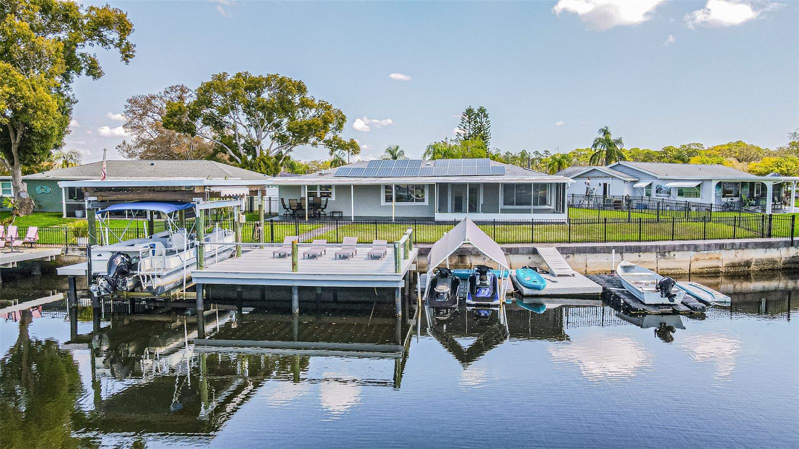 Waterfront Living at its Finest –

Nestled in a luxury, family-friendly neighborhood in Holiday, Florida. This stunning 3-bedroom, 2-bath waterfront home with nearly 1,900 sq ft.  It offers the perfect blend of comfort, style, and a ultimate Florida boating lifestyle. This property is a true fisherman’s paradise with direct access to the Anclote River and just a short boat ride to the famous Tarpon Springs Sponge Docks then out to the Gulf of Mexico.

A Home Designed for Comfort & Style.

Step inside to an open-concept floor plan with seamless tile flooring throughout.  This creates a clean and modern flow perfect for entertaining with everyday living. The custom kitchen is a true centerpiece, featuring:

Striking waterfall marble countertops,

black stainless steel appliances,

generous prep including entertaining space and

clear sightlines to the living and outdoor areas.

The spacious primary suite is your private retreat, highlighted by a luxury wet steam room (5' x 9.5') large enough to accommodate multiple people-bringing spa-level relaxation right into your home.

Additional upgrades include:

Instant hot water heater – never run out of hot water,

solar panels for energy savings,

freshly painted,

custom entry doors,

newer roof, HVAC system, and windows.

Outdoor Living Built for the Florida Lifestyle.

This home truly shines outdoors. Relax or entertain from the screened-in patio overlooking the water, or take advantage of the huge covered patio with plenty of space for outdoor toys and gear.

The beautifully maintained property also includes:

New St. Augustine grass installed last year with irrigation system with its own well and on it's

completely fenced side yard and backyard.

Doggie door for convenient pet access,

stamped cobblestone concrete driveway,

super gutters installed around the entire home,

two-car garage with professional epoxy flooring and warranty.

Boater & Angler’s Dream!

Situated at the end of the Anclote River, the property offers brackish waterfront known for abundant redfish and snook—often caught right off the dock.

Your private waterfront setup includes:

10,000-lb boat lift,

large oversized dock for entertaining,

floating docks for kayaks, paddleboards, and water toys.

double floating wave-runner dock available and

recapped and stamped seawall.

From your dock, enjoy a short scenic boat ride to the sponge docks, waterfront restaurants, and open Gulf waters. FYI this property has never flooded.

Location Perks:

You’re just minutes from:

Gulf beaches,

waterfront dining,

boating and fishing hotspots,

parks and local amenities.
All while enjoying the tranquility of a quiet waterfront neighborhood perfect for families or those seeking the ultimate coastal lifestyle.

Whether you’re a boater, fisherman, entertainer, or simply looking for the perfect waterfront retreat, this property delivers the Florida lifestyle at its absolute best.
