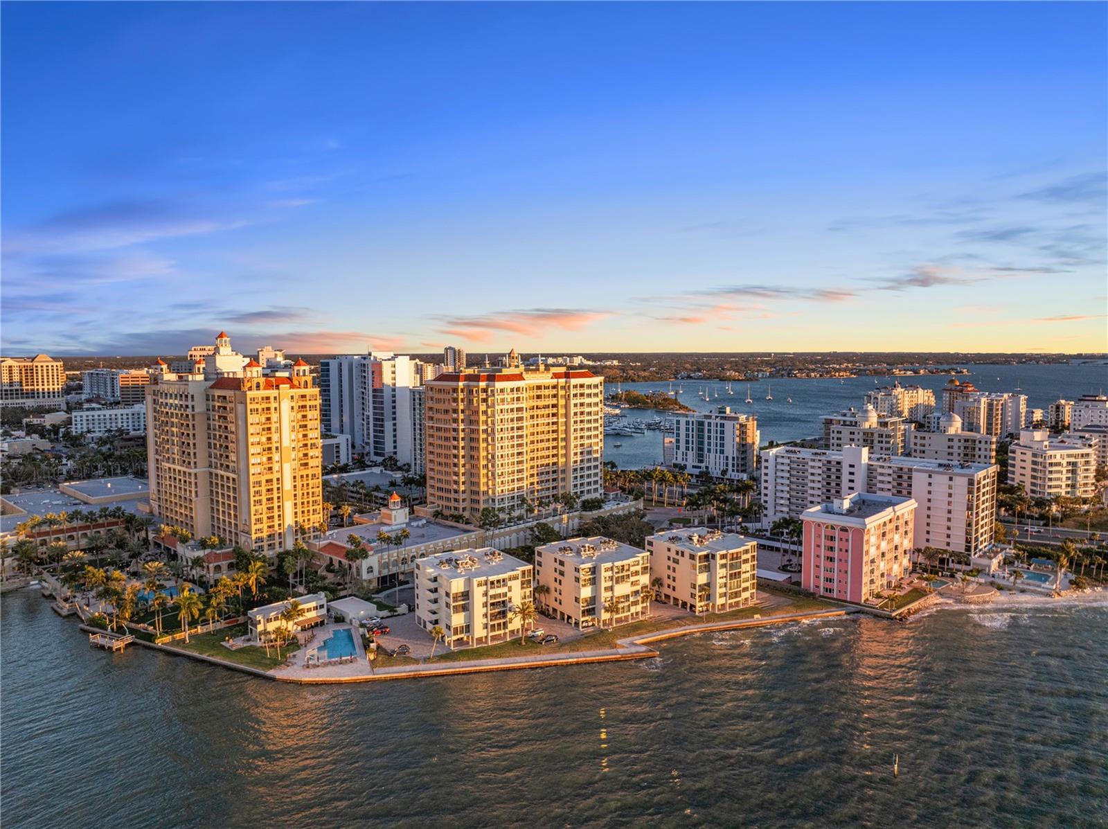 Rare opportunity to own in the architecturally significant Lawrence Pointe community—>offering some of the lowest condo fees on Sarasota’s Downtown Bayfront. Finding a true three-bedroom, three-bath residence with direct Bayfront views at just $1,261.67/month in condo fees is virtually unheard of, making this an exceptional value for waterfront living. Even better, your Sarasota Bay views are protected, meaning you’ll never have to worry about future development obstructing what you see today. Designed by renowned Sarasota School of Architecture architect Tim Seibert, this spacious fourth-floor residence offers over 2,000 square feet of light-filled living space. The open floor plan is thoughtfully designed to capture tranquil bay views while still feeling comfortable for everyday living and effortless for entertaining. Inside, you’ll find a wet bar perfect for hosting, along with a dedicated office nook ideal for remote work or a quiet workspace. The third bedroom is currently set up as a flexible living area and can easily transition into a guest suite, den, media room, or home office depending on your needs. A generous utility room with full-size washer and dryer, laundry sink, and additional storage which adds a level of functionality that’s rarely found in condo living. This boutique waterfront community features a heated bayfront pool, secure entry, and covered parking, all just minutes from downtown Sarasota’s dining, shopping, arts, and marina district. You’re also just a short drive to Lido Key and St. Armands Circle, giving you the perfect balance of city convenience and coastal lifestyle. A timeless Bayfront residence in one of Sarasota’s most desirable and architecturally celebrated communities.