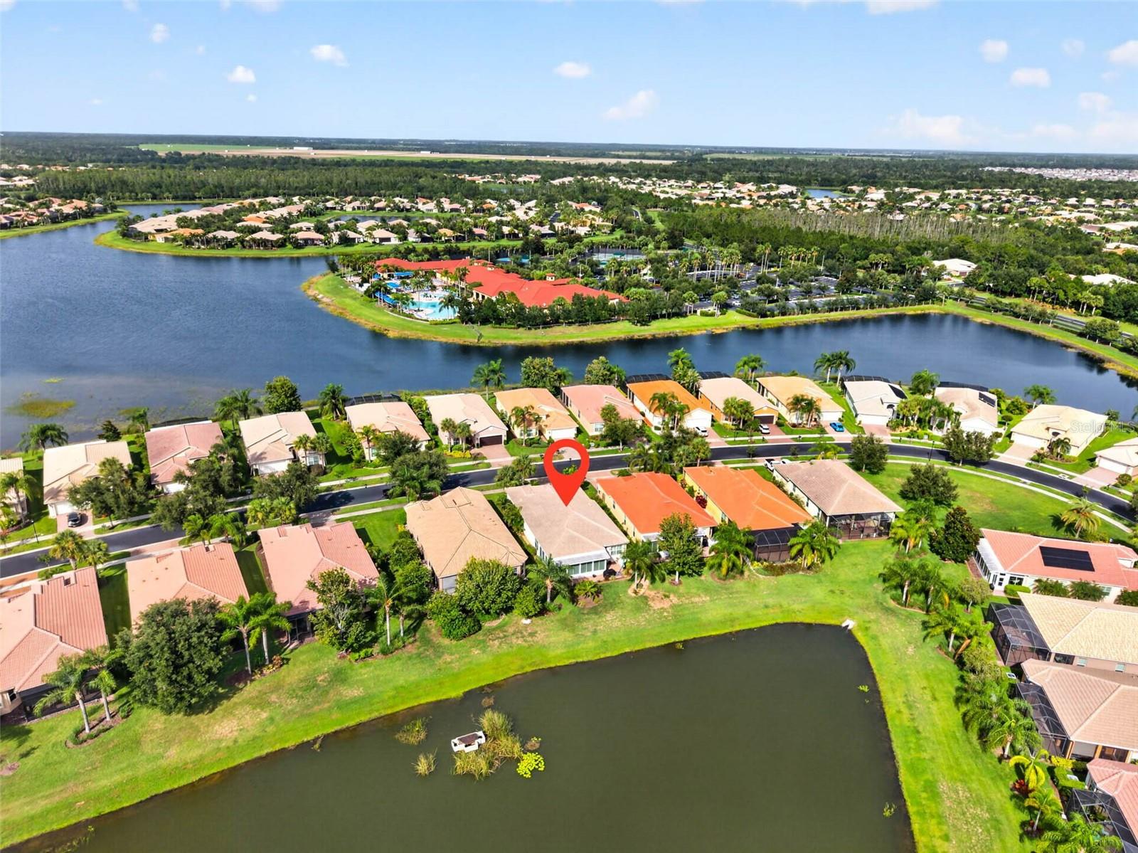 Welcome to Valencia Lakes, where every day feels a little more like vacation. Where neighbors become friends, your social calendar stays full, and your weekends are whatever you want them to be. Whether that's pickleball in the morning, lunch at the café, a fitness class, happy hour with friends, or simply enjoying the peaceful lake view from your own backyard, this is a community designed to help you make the most of every day. Perfectly positioned on a tranquil lakefront homesite, this beautifully maintained three-bedroom, two-bath home home offers the ideal combination of comfort, low-maintenance living, and one of Tampa Bay's most sought-after 55+ lifestyles, welcoming you with peaceful water views from the moment you walk through the front door. The open floor plan creates an effortless flow between the kitchen, dining, and living areas, making it equally suited for entertaining friends or enjoying a quiet evening at home. The spacious kitchen offers abundant cabinetry, stainless steel appliances, stone countertops, a marble backsplash, and a breakfast bar for casual dining. Just beyond, the four-season Florida room extends your living space and may quickly become your favorite place to unwind, offering panoramic lake views in air-conditioned comfort all year long. The primary suite is a relaxing retreat featuring high ceilings, generous closet space, and an ensuite bath with dual vanities, a soaking tub, and a separate walk-in shower. Two additional bedrooms provide flexibility for visiting family, overnight guests, or a dedicated office or hobby space. The interior was freshly painted in 2023, and the home has been well maintained. Notable dates inclue HVAC (2012) with a new fan motor and compressor motor installed in February 2024. Hot Water Heater (2020) and Tile Roof (2012). And the best part? Life here is wonderfully simple. The HOA covers lawn maintenance, irrigation, premium cable, high-speed internet, trash, and 24-hour gated entry, giving you the freedom to lock the door and spend your time doing what you love instead of maintaining a home. Valencia Lakes is one of Tampa Bay's premier 55+ communities, centered around a spectacular 40,000-square-foot clubhouse offering endless opportunities to stay active and connected. Residents enjoy resort-style and lap pools, seven pickleball courts, six Har-Tru tennis courts, bocce, shuffleboard, softball, a state-of-the-art fitness center with instructor-led classes, on-site dining at Mattison's Café, spa services, walking trails, and a full calendar of clubs, concerts, and social events. This isn't just a beautiful lakefront home. It's the beginning of your next chapter where the amenities feel like a resort and every day is yours to enjoy.