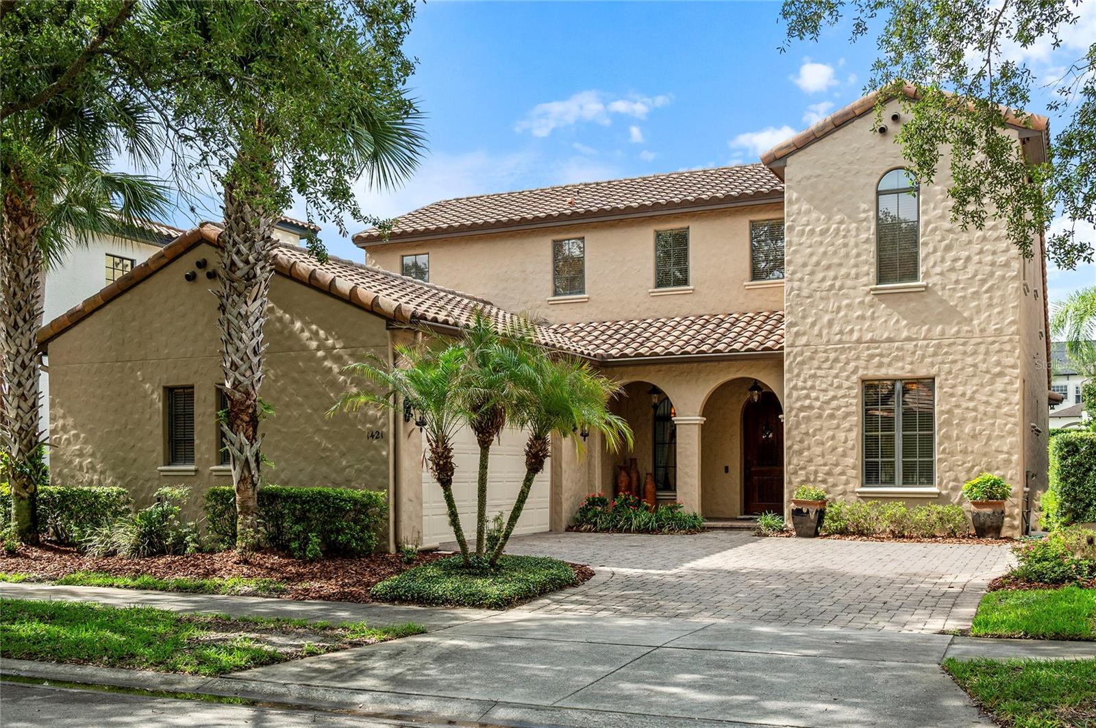 Welcome to 1421 Chapman Circle, an elegant Spanish-Mediterranean home nestled within the highly coveted Windsong community in the heart of Winter Park. From the moment you arrive, the classic barrel tile roof and timeless architectural character set the tone for what awaits inside — a home with enduring style, gracious proportions, and tremendous potential to be personalized for its next chapter.

Spanning over 3,500 square feet, this 4-bedroom, 3.5-bath residence offers a formal, well-appointed layout with soaring high ceilings, rich crown molding, and a thoughtful floor plan designed for both comfortable daily living and effortless entertaining. A dedicated first-floor office provides the ideal work-from-home space, while the separate formal dining room adds an air of sophistication perfect for hosting family and friends.

The gourmet kitchen is the heart of the home, featuring granite countertops, premium Thermador appliances, and bartop seating — a space equally suited for casual mornings and lively gatherings. The living room opens through French doors to a generous wrap-around screened patio, seamlessly blending indoor and outdoor living in true Florida fashion.

The first-floor primary suite is a private retreat, complete with French door access to the patio, a spacious walk-in closet, and a well-appointed en suite bath featuring a double sink vanity, a separate soaking tub, and a walk-in shower. Upstairs, three generously sized guest bedrooms share a hall bath, and a large bonus room and landing offer flexible space for a playroom, media room, or additional lounge area. A large upstairs utility room and additional walk-in storage beneath the stairs ensure that function is never sacrificed. The home is served by two HVAC units, both dated 2017.

Beyond the front door, the Windsong community is nothing short of exceptional. Residents enjoy access to two resort-style pools, a splash pad for the little ones, scenic parks, a fishing dock, and coveted chain-of-lakes access complete with use of a community boat — a lifestyle that truly sets Windsong apart. Zoned for A-rated schools and ideally situated just minutes from the vibrant energy of Baldwin Park, Audubon Park, the Mills District, Downtown Orlando, and all that Winter Park has to offer, this address places you at the center of everything.

Whether you're drawn to its classic architecture, its unmatched community amenities, or the incredible opportunity to update and truly make it your own, 1421 Chapman Circle is a rare find in one of Central Florida's most beloved neighborhoods.